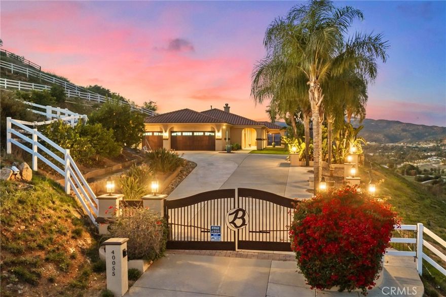 Experience peaceful La Cresta living in this beautifully maintained single-story Mediterranean home, perfectly positioned to take in
sweeping mountain and city-light views. From the moment you walk in, the open floor plan, vaulted ceilings, wood beams, and
natural light create a warm and inviting feel that’s ideal for both everyday living and entertaining. The great room features a cozy
fireplace and flows effortlessly into the oversized gourmet kitchen, complete with granite countertops and plenty of space for
gatherings. The primary suite is privately tucked away on its own wing of the home and offers incredible views along with a
spacious, spa-like bathroom. The additional bedrooms sit on the opposite side, giving everyone their own comfortable space. Step
outside to a true outdoor oasis. A luxury pool and spa overlook some of the most beautiful views in La Cresta—perfect for morning
coffee, relaxing afternoons, or sunset evenings with friends. The yard also includes a sunken firepit, built-in BBQ, and an outdoor
bathroom, making it a great setup for entertaining year-round. The 5.84-acre property is thoughtfully laid out with mature citrus
trees—orange, lemon, and lime—along with a small avocado grove. There’s plenty of room for horses, a barn, workshop,
guest house, or simply enjoying the open space and tranquility.