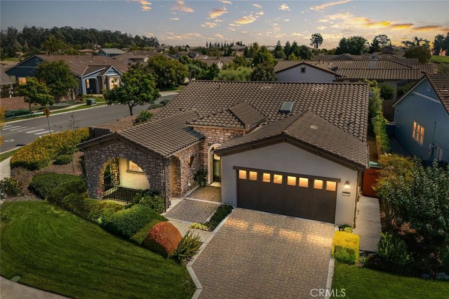 Resort living awaits in this Lopez home with a lovely stone facade, spacious porch and beautiful landscaping, located on the corner of a pristine cul-de-sac. At 2,079 sq. ft., this well-appointed home offers 2 bedrooms, 2 baths, and a den, plus a clever closet/partial garage conversion which has resulted in a spacious office/study, complete with gorgeous built-ins. Another notable upgrade - multiple skylight tubes throughout to bring in even more natural light. The great room features a cozy fireplace and luxury entertainment center which opens to the chef’s kitchen, a sunny breakfast nook, a built-in desk and direct patio access - it’s a great spot to enjoy your morning coffee while catching up on email. The adjacent chef’s kitchen offers a super efficient set-up featuring GE Profile stainless appliances, including a wall oven/microwave combo and gas cooktop, KitchenAid dishwasher, LG French door refrigerator, rich Shaker-style espresso cabinetry with lots of pot drawers, gorgeous granite island and countertops and smart pendant lighting. An extended Butler’s pantry is located in the adjacent formal dining room, making entertaining your guests a breeze. Head outside and experience a delightfully private and low-maintenance backyard with extensive pavers, planted with trees, shrubs and flowers - it’s your go-to spot to simply relax and enjoy Central Coast living. In the evenings, retire to your primary suite - a spacious bedroom with direct patio access, plus a master bath with dual sinks, decorative tile backsplash, tile shower with seamless glass enclosure, a large walk-in closet and linen storage. Up front is the 2nd bedroom with a full en-suite bath, plus the den, which could easily be converted into a 3rd bedroom. In addition, there’s a laundry and 2-car garage. Best of all, this delightful Lopez home is located in Trilogy Monarch Dunes with Adelina’s Bistro, Sandalwood Spa, art studio, pool, fitness center, pickleball courts, and so much more.