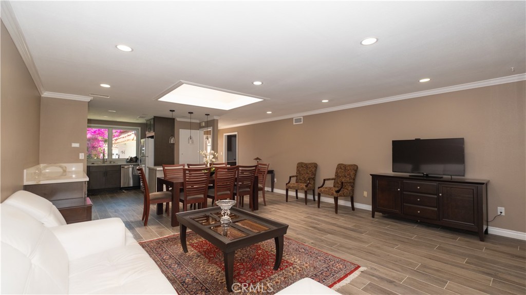 Offered at $1,188,888, 7 Satinwood represents more than just a home—it’s a symbol of prosperity, longevity, and thoughtful design. Located in the heart of University Park’s desirable Village III, this fully detached single-level residence has been completely remodeled with elevated finishes and tasteful modern touches.
A bright, open layout welcomes you in with a dramatic skylight, wood-look porcelain flooring, and crown molding throughout. The custom kitchen is outfitted with quartz countertops, mosaic backsplash, and new stainless steel appliances, framed by a large window overlooking a lush courtyard. An adjacent bar nook makes entertaining effortless. Both bathrooms feature full custom tilework, including a dual vanity in the primary suite, which also offers private patio access through a sliding glass door.
Enjoy outdoor living across two patios—one front-facing, one private in back. An oversized two-car garage offers generous storage, and an electronically keyed gate adds privacy and security. The community offers greenbelts, pools, tennis courts, and tree-lined walking paths, all nestled within a peaceful neighborhood setting.
University Park is minutes from UC Irvine, Irvine Valley College, Chapman University, and Cal State Fullerton. Zoned for award-winning Irvine Unified schools including University High, Rancho San Joaquin Middle, and Bonita Canyon Elementary. Nearby cultural staples include Wholesome Choice Market, Beth Jacob Congregation, University Synagogue, and Congregation B’nai Israel, plus a vibrant selection of Asian and international markets, restaurants, and wellness centers.
A rare opportunity to own in one of Irvine’s most culturally rich and centrally located communities—with prosperity built right into the address.