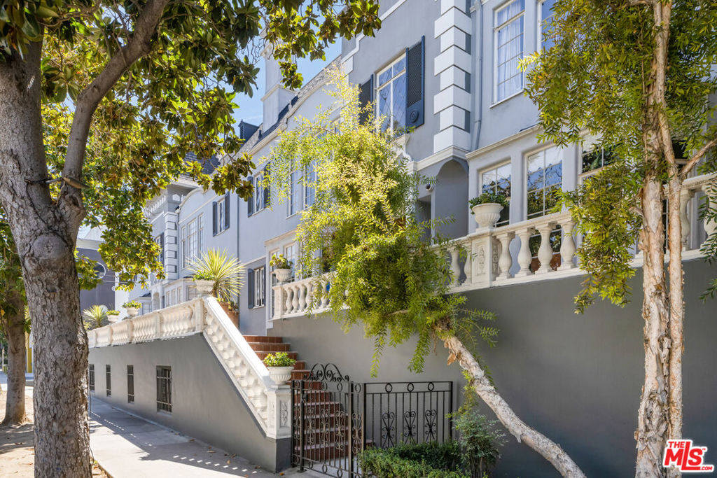 Charming 1930's French Chateau-Style Condo by Arlos Sedgley, Architect in the heart of Koreatown - Los Angeles Historic Cultural Monument #815 with significant property tax savings through the Mills Act. The spacious one bedroom, one bath upper floor unit is bathed in natural light with generous storage at the highly desirable French Chateau. The building was converted and meticulously renovated in 2007. Stunning original details include; Art Deco light fixtures, hardwood flooring, crown moldings with period detailing including archways and crests throughout. This inviting home offers a light airy ambience in a gracious setting. The oversized living room features steel-frame windows that overlook stunning magnolia tree-tops and includes built-ins and sunlit vistas. The kitchen hosts original-detail cabinetry and tiling, European stainless steel appliances with a pantry and adjacent formal dining area. The bedroom has multiple closets with separate dressing area. A connected bath, with original tile work in vibrant green, is characterized by subtly coved ceilings and cabinetry tinged with a French Moderne style. Unit 8 has both a main and service entrance and there is a subterranean parking garage with 2 side-by-side parking spaces. The condo also features central air & heat and an in-unit washer/dryer. With only ten units in the building this is a special opportunity to become the next custodian of a legendary property.