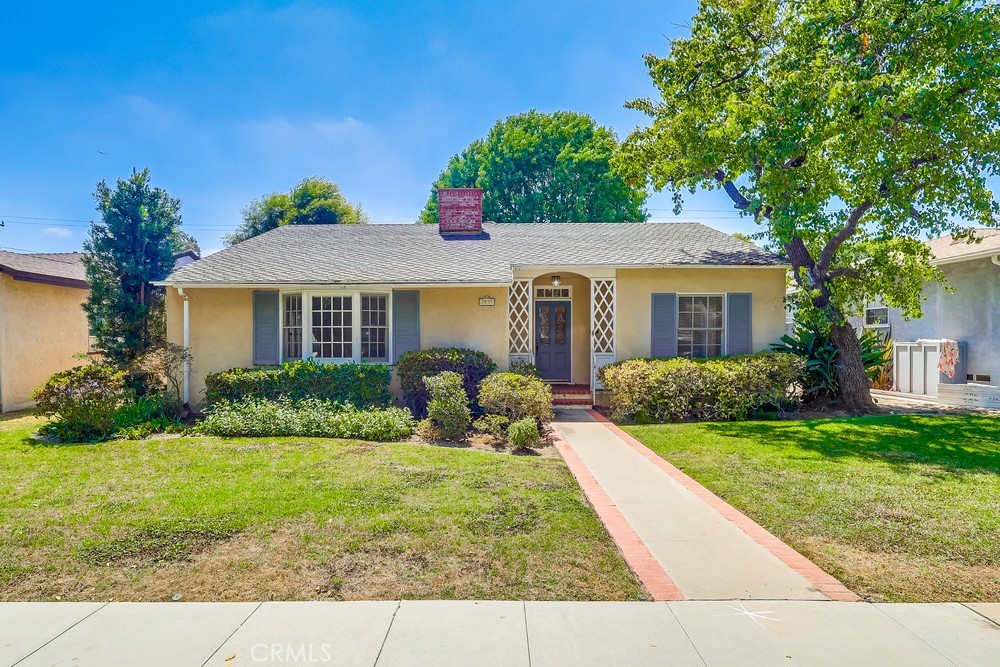 Charming Bixby Knolls home with Spacious Layout and Lush Backyard. Welcome to this inviting single family home in the heart of Bixby Knolls. Offering 3 beds/2 baths, and over 2100 square feet of living space, It sits on a generously sized lot, and combines classic character with everyday comfort. Inside, you'll find a spacious and versatile floorplan featuring both carpet and hardwood flooring, exposed beamed ceilings, a formal dining room, both a large living room and a family room - perfect for relaxing or entertaining. There are two skylights that provide plenty of natural light. The spacious kitchen includes stone countertops and plenty of storage, and the ensuite primary bedroom provides a private retreat. Step outside to the beautful backyard with mature trees, a covered patio, and a brick fireplace, ideal for outdoor dining and gatherings year-round. Additional features include in-unit laundry and a 2-car garage. Conveniently located within walking distance to schools, shopping and dining, just 3 blocks from a bus stop, and one mile from the Blue Line station, you have the ideal blend of tranquility and accessability. Don't miss this opportunity in one of Long Beach's most desirabe neighborhoods.