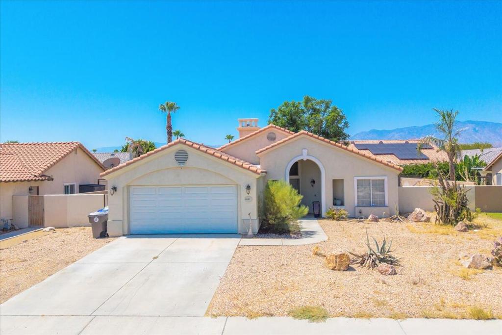 There's something special about walking into a place that instantly feels like home. Tucked away on a quiet cul-de-sac in Cathedral City, this beautifully updated residence welcomes you with an open layout, vaulted ceilings, and the warm glow of a living room fireplace. The kitchen is the heart of the home, offering generous counter space, a gas range, double ovens, and ample cabinetry--ready for everything from quiet breakfasts to holiday meals. With three bedrooms, two bathrooms, and a spacious two-car garage, there's room to grow, settle in, and make memories. Step outside to a low-maintenance backyard with a covered patio perfect for weekend barbecues or evening unwind time. Just minutes from parks, schools, and local shopping, this is more than a house--it's the place where life happens.
