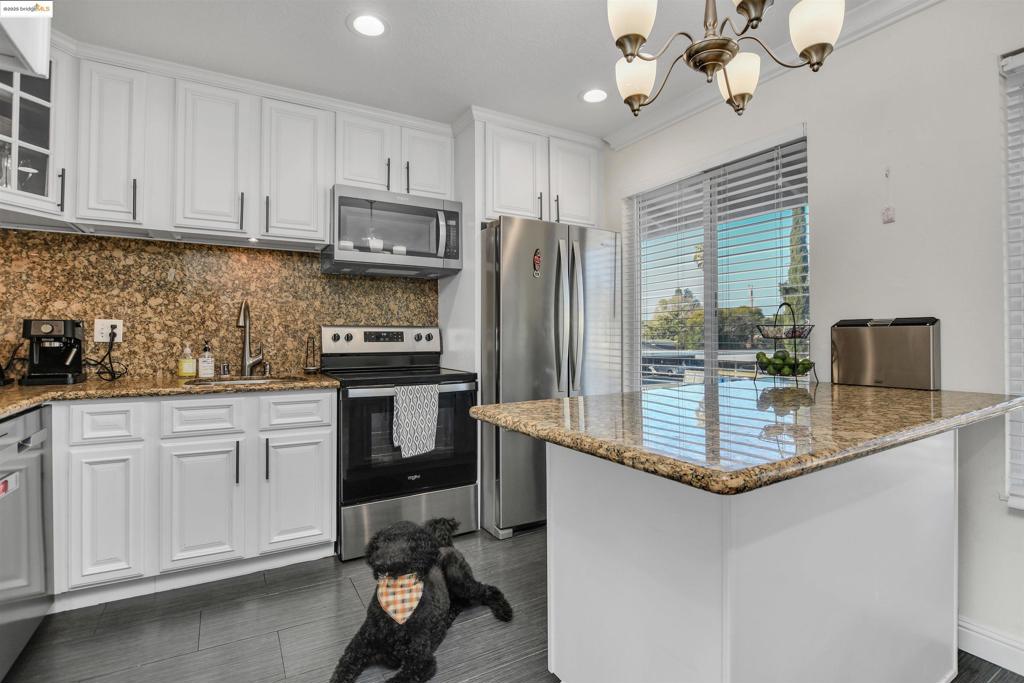 This beautifully upgraded 1 bedroom condo offers a perfect blend of comfort and style. The open floor plan creates a spacious, airy feel, with the added benefit of privacy provided by a stylish barn door. The unit is well-appointed with modern upgrades throughout, ensuring both functionality and sophistication. Step outside to the oversized patio, which boasts a serene view, perfect for relaxing or entertaining. For added convenience, the condo comes with one covered parking spot, plus an additional parking spot is included for 2025. This condo combines modern living with thoughtful details, offering an ideal retreat in a prime location.