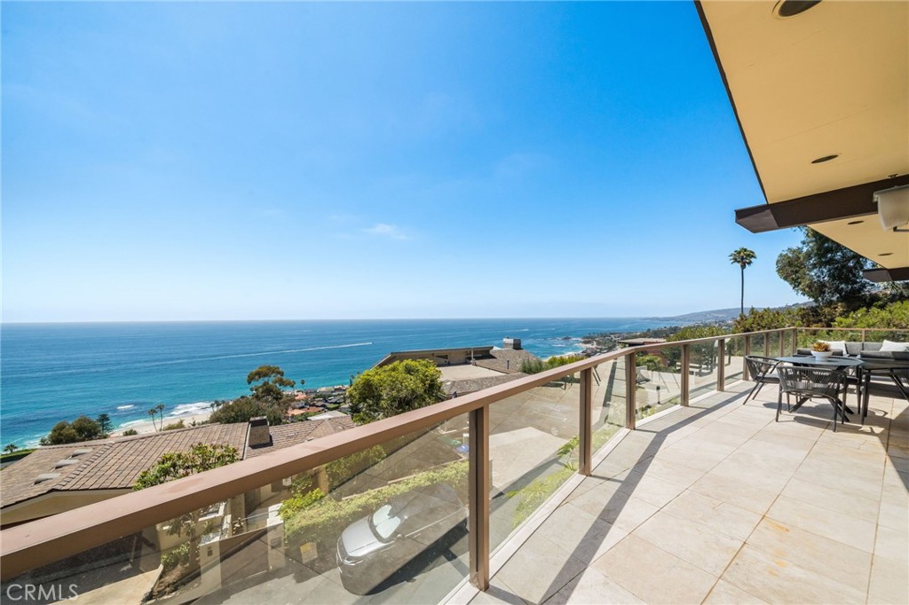 Set overlooking Laguna Beach on the serene and sought-after Coast Royale in Laguna Beach, 31272 Ceanothus Drive takes in panoramic views that stretch from the Montage Resort and Emerald Bay to the distant skyline of Long Beach. Catalina Island sits perfectly centered in the horizon, providing a daily front-row seat to the ever-changing, remarkable sunsets. A spacious deck off the main living area invites the sort of outdoor living we treasure in Southern California, providing a perfect setting to unwind and take in the tranquility. It’s an inspiring backdrop for calm mornings, creative thinking, or simply enjoying the moment.
Inside, the home features soaring beamed ceilings in the living room and beautiful hardwood floors that add warmth and character throughout. The kitchen and living areas flow seamlessly to the outdoor spaces, creating an expansive, view-filled space to relax or entertain. The kitchen is a centerpiece for the home - outfitted to encourage your inner chef in an inspiring setting. The primary suite is privately situated and generously sized, with whitewater views that greet you each morning. Open the windows and let the rhythmic sound of crashing waves lull you to sleep.
In addition to the main living areas, the home includes several versatile flex spaces to suit your lifestyle. One room features built-in shelving and a custom desk, making it ideal for a home office. Another space offers the perfect setting for a home gym or creative studio. An oversized laundry room adds extra function and convenience, with room for storage or expansion. The beach is just a short jaunt, and a favored 'locals' park and restaurants allow you to enjoy life without leaving your neighborhood.
31272 Ceanothus Drive a wonderful opportunity to enjoy elevated coastal living in a peaceful Laguna Beach neighborhood, just minutes from the best of Laguna Beach and southern California!