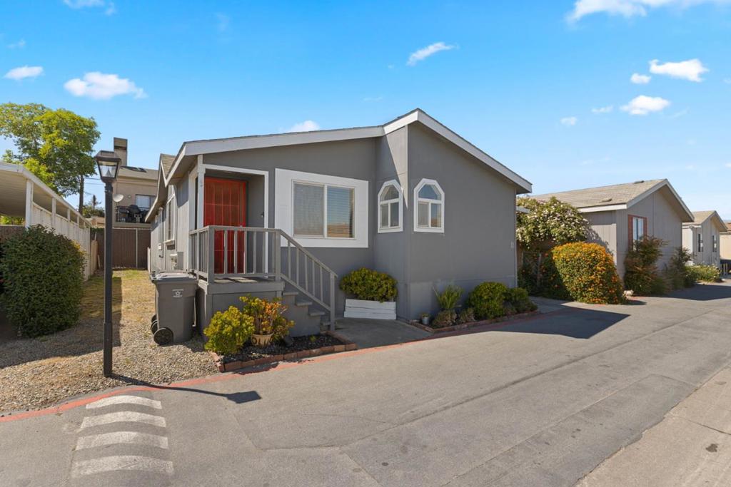 You need to see this one! This cheerful and updated double-wide home in an all-age park offers approximately 1,456 sq ft of comfortable living space with 3 bedrooms and 2 bathrooms including a freshly remodeled primary bath you'll love including new porcelain bathtub, sink, tiled vanity, toilet, tiled shower tub area, bathtub fixtures, sink fixtures, new tile flooring. The vibrant backsplash in the kitchen adds personality and warmth and with the same coordinating color in the breakfast nook makes for a cheerful area. Kitchen comes equipped with a newer stove, range hood, faucet, garbage disposal, and updated light fixtures in both the breakfast nook and dining area. Enjoy the ease of an indoor laundry room, another perk is the digital thermostat. Newer front porch with steps and a security screen door, covered carport, and an outdoor storage shed. Even better this home is perfectly located just across from guest parking and short distance to the community pool and post boxes. You will appreciate easy access to schools, shopping, and for the commuters highway access.. Everything about this home says comfort, convenience, and style. Don't miss your chance this is the one you've been waiting for!