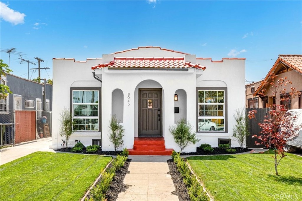 Welcome to this stunningly transformed Spanish Revival home in the heart of Jefferson Park, where timeless character meets modern upgrades. This thoughtfully reimagined property offers warm, inviting spaces, Step into a front yard adorned with new sod and carefully selected plants, setting the stage for the serene retreat that lies beyond. The rear yard is framed by lush hedges, creating a private oasis perfect for entertaining or relaxing. A long driveway add extra off street parking. Inside, the light-filled living and dining areas feature natural light streaming through new dual-glazed, low-e windows. New LVP hardwood floors anchor the open-concept spaces, while all new fixtures add a curated sense of style. The custom kitchen is both beautiful and functional, with White quartz countertops, a statement tile backsplash, and self-closing cabinetry. Stainless steel appliances, including a gas range, dishwasher, and large kitchen island make this space a dream for cooking and entertaining. Conveniently placed washer and dryer hookups ensures everyday tasks are effortless. The primary suite is a sanctuary, featuring a spa-like en suite bathroom with a walk-in shower, double vanity, and a free standing soaking tub. Bathrooms throughout the home feature sophisticated tilework from Bedrosians and Arizona Tile, blending artistic design with modern luxury. Extensive system upgrades ensure this home is as functional as it is beautiful. A new HVAC system and new ducting ensures year-round comfort. The home also boasts updated plumbing, including a new water heater, and updated wiring. The detached garage can be converted into a versatile flex space, complete with sliding glass door. Whether it becomes your creative studio, or gym, this additional space is ready to adapt to your lifestyle. Situated near some of the best dining and shopping in Los Angeles, including Whole Foods, Johnny's Pastrami, South LA Cafe, Vicky's All Day, this home offers not only architectural charm but also close proximity to vibrant community hotspots. This revived Spanish gem invites you to enjoy the perfect blend of historic character and modern convenience, all within one of LA's most beloved neighborhoods.