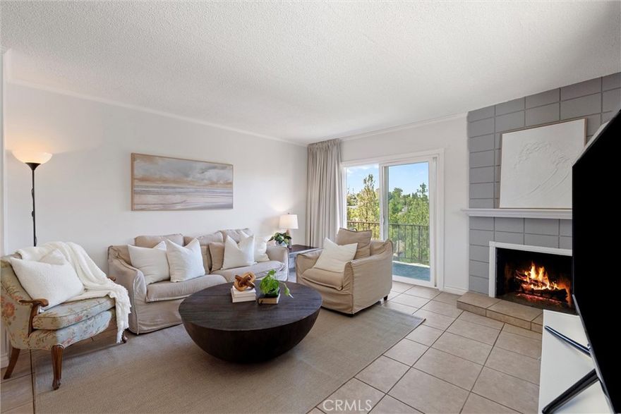 This light-filled, top-floor end unit offers 2 bedrooms, 1.75 bathrooms, and approximately 1,170 square feet of single-level living. Thoughtfully maintained, this home features a private balcony with peaceful mountain and treetop views, accessible from both the living room and bedrooms. The kitchen offers potential to be opened up, creating an even more inviting open floor plan with expanded sightlines to the view.



The living room includes tile flooring, a fireplace, and flows into the dining area and kitchen. Other highlights include newer windows throughout, an in-unit laundry room, and two secured subterranean parking spaces.



The HOA offers great amenities including a pool, gym, and more. Conveniently located just 2.5 miles from Cal State Fullerton and Fullerton College, and only 1.5 miles from Providence St. Jude Medical Center.



This condo offers flexibility. Whether you're a first-time buyer looking to build equity, a student looking for an alternative to campus housing, or a buyer exploring rental income potential, this home is well-located and easy to make your own.