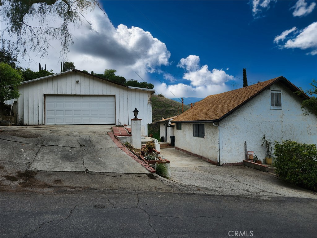 **Charming Fixer with Stunning Views in the Highly Sought-After Kagel Canyon area of Sylmar** Nestled in the desirable **Kagel Canyon** community is this rare double-lot fixer-upper with two separate parcels (2526-009-017 & 2526-009-016) that offers endless potential and breathtaking views. The combined side by side lots total about 11389sqft. This fixer-upper is a rare opportunity for investors or buyers looking to create their dream home in a serene, nature-filled setting. With ample space and tons of potential, this property is waiting for the right vision to bring it to life. This two-level home features 3 bedrooms, 2 baths (tax accessors only show 2+1), upper dining area and a lower-level family room. It also has a small little basement as an added bonus. The other lot has a garage (no permits found) that can be used for a workshop and also has an extended room on the back of the garage. This property is a fantastic opportunity and is priced to sell ASAP. Well-situated near shopping, dining, entertainment and recreation areas like the Hansen Dam Equestrian Center, Kagel Canyon Park and conveniently located near major freeways (210, 118, 405, & 5). Don’t miss out on this rare chance to own in Kagel Canyon—bring your tools and imagination to transform this diamond in the rough!