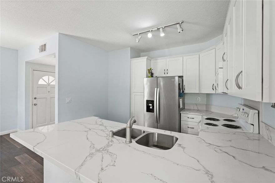 This turnkey single-story, 1st floor condo at 2426 Pleasant Way, Unit E, Thousand Oaks, CA 91362 offers 2 bedrooms, 1 bathroom, and 907 square feet of thoughtfully designed living space and a brand new HVAC!



The open kitchen features white cabinetry, quartz countertops, stainless steel refrigerator, dishwasher, microwave and electric oven. The kitchen flows seamlessly into the living and dining areas, providing an ideal layout for everyday living. The spacious primary bedroom includes a generous walk-in closet and sliders providing direct access to the patio. The second bedroom offers flexibility for guests or a home office. Additional highlights include a well-appointed bathroom, in-unit washer and dryer, fireplace and central air conditioning.



Step outside to a private wrap-around patio overlooking a lush park setting. Community amenities include a pool, spa, and beautifully maintained common areas. HOA dues cover water, sewer and trash service for added convenience. The neighborhood park is directly across the street, enhancing the indoor/outdoor enjoyment of this lovely home. 



Situated in a prime Thousand Oaks location, the home is close to The Oaks Mall, Janss Marketplace, award-winning schools, local parks, and dining options, with easy access to the 101 Freeway. * Please note that some photos are virtually staged *