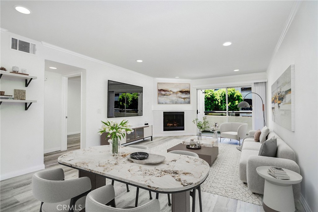 Resort style living in the heart of Warner Center, welcome to The Met! Immaculate 2 Bed + 2 Bath condo located on the 1st floor of building #2. Turn key West facing unit drenched in natural light, walking distance to the main pool, gym & tennis courts. Certainly the most desirable floor plan, this style utilizes an open concept with a guest bedroom and full bath up front, while the master sits at the back of the unit with views of the exterior! The master bedroom also offers a luxurious en suite bathroom featuring updated tile flooring with double vanity sinks in addition to an enormous closet. This spacious and beautiful condo features such upgrades as luxury vinyl plank flooring (NO CARPET), recessed LED lighting throughout, gas fireplace, granite countertops & stainless steel appliances. Designated dining room for more formal eating yet with open views to the living area and outdoor space. A peaceful West facing balcony sits off the living room, ideal for a BBQ and/or outdoor sitting area. Last but not least, your very own WASHER & DRYER IN THE UNIT, 2 COVERED parking spaces in the garage below & extremely close proximity to the lobby elevator!!! The Met is a guard gated community that offers 4 resort-style swimming pools, six night lighted tennis courts, full fitness center, racquetball, indoor basketball court, multiple spas & 24 hour guard gated security. All this located within walking distance to The Village, Warner Center Park and all the dining, shopping & entertainment Warner Center has to offer.
