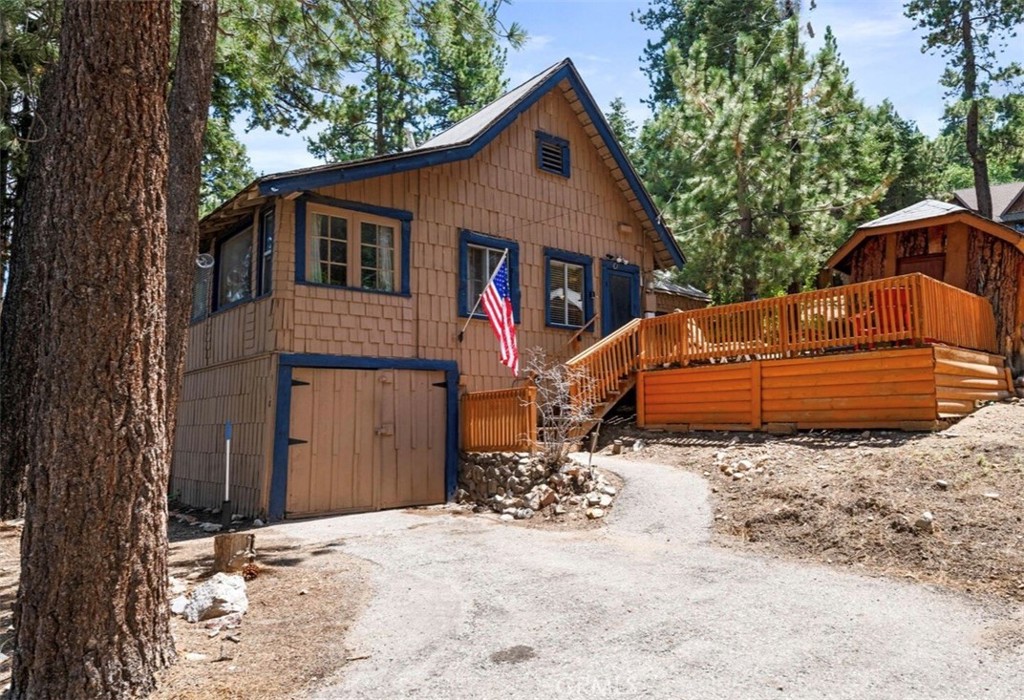 Ideally situated within walking distance to Bear Mountain Ski Resort, the golf course, Moonridge Zoo, and numerous trail systems, this updated vintage cabin offers comfort, charm, and investment opportunity.
The interior features classic knotty pine tongue-and-groove walls and ceilings, a striking native stone wood-burning fireplace, and granite kitchen countertops with a cozy dining nook. The one-bedroom layout includes a full bathroom with an antique clawfoot tub and separate shower.
Well-maintained and thoughtfully upgraded, the home includes a newer roof (2017), storm windows, and an extended driveway with RV parking. The detached one-car garage may qualify for a junior ADU or studio conversion (buyer to verify), and the oversized yard presents further expansion or ADU potential.
Sold fully furnished, this cabin has a proven track record as a seasonal short-term rental and is ready for immediate use or income generation. Don't miss this unique opportunity to own in the highly desirable Moonridge neighborhood.
