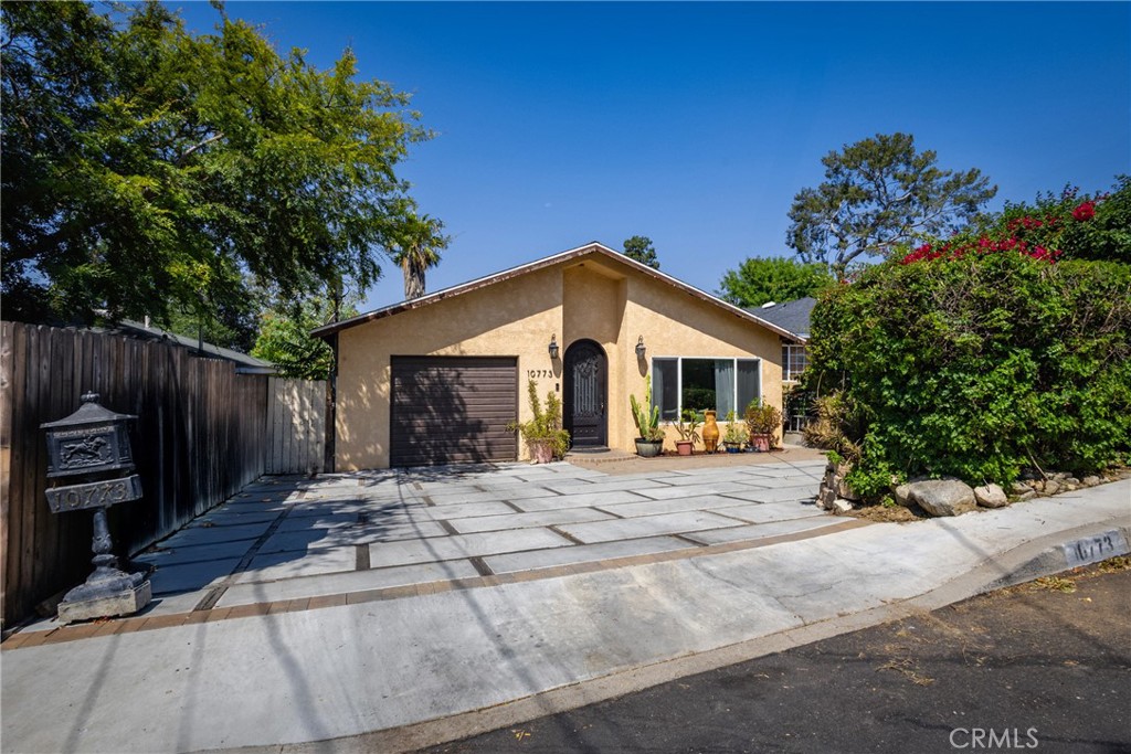 Nestled in a peaceful cul-de-sac near the famous E.T. House, this beautifully updated 2-bedroom, 2-bath home offers comfort, charm, and modern upgrades throughout. Step into the spacious living room featuring soaring vaulted ceilings, natural light and a remodeled 3/4 bathroom for guests. The open dining area flows into the galley kitchen complete with stainless steel appliances, granite countertops, and a cozy breakfast nook. Both bedrooms are generously sized and share a full hallway bath. The partially finished attached garage includes a split A/C system and a laundry area, great for added functionality or creative use. Recent upgrades include a newer roof, central A/C system, electrical panel and wiring, dual-pane windows, copper plumbing, recessed lighting, hardwood floors, and a Level 2 electric car charger. In the backyard, enjoy the large redwood deck with scenic mountain views and a step-down patio ideal for entertaining. The spacious yard also features open space for children or pets, multiple fruit trees (orange, tangerine, apple, and fig), and a Tuff Shed for extra storage. This home truly combines peaceful living with thoughtful updates and outdoor enjoyment.