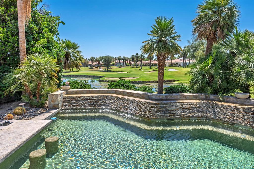 Welcome to a rare opportunity in PGA West, situated on a premium oversized lot with an expansive driveway and unbeatable east-facing views of the iconic ''Lily Pad'' 8th hole of the Jack Nicklaus Tournament Course. Wake up to breathtaking sunrises over shimmering lake and lush green vistas--all while being safely out of range from any stray golf balls. The resort-style pool offers its cascading water feature and a picturesque lake backdrop. Entertain with ease at the sunken built-in BBQ area, complete with stool seating in the pool, making it the perfect gathering spot for friends and family. This beautifully designed home features a highly efficient open floor plan with no wasted space, perfect for entertaining and everyday living. A large, detached private casita provides the ideal guest retreat or home office. At the same time, a tranquil front courtyard with a cascading water feature sets the tone for peace and relaxation from the moment you arrive. Energy efficiency is built in with rooftop solar panels that help significantly reduce electricity costs. Offered fully furnished, this home is move-in ready for immediate enjoyment. As a PGA West resident, you can join as a member and experience an unmatched lifestyle featuring six championship golf courses, three clubhouses, pickleball and tennis courts, bocce ball, and a resort-style Olympic lap pool with private cabanas. Enjoy on-site dining at multiple restaurants, or unwind in the clubhouses with amenities like pool tables, ping pong, and more. Don't miss this rare chance to own one of the most desirable view lots in PGA West. Schedule your private showing today and start living the desert lifestyle you deserve!