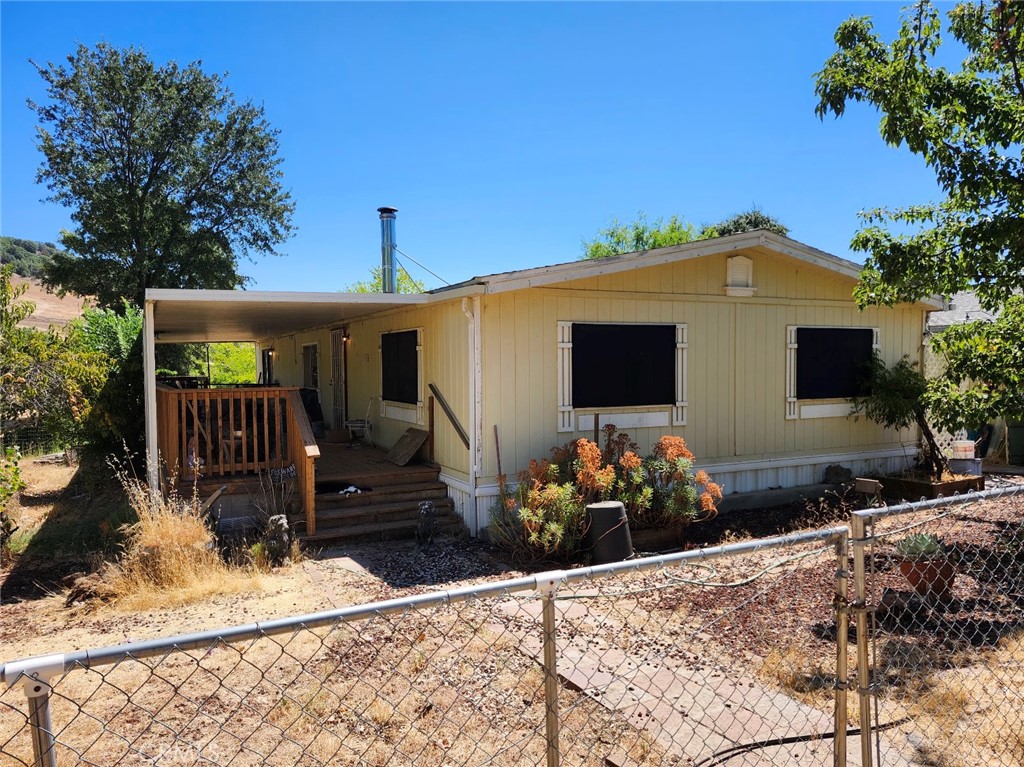 Don't Miss This Amazing Home on Large, 7/10 Acre Lot With 2 Separate Garages Totaling 6 Car Spaces. Manufactured Home is Spacous With a Large Covered Deck. The Property Boasts Many Producing Fruit Trees, Watered From the Private Well on the Property. Property is Fenced Including a Yard for the Dogs. There is a Koi Pond Full of Fish and a Nice Pergola Covered With Wisteria Where One Can Enjoy the Pond and the Coolness of the Shade.
The Neighboring Lot is Available Separately.