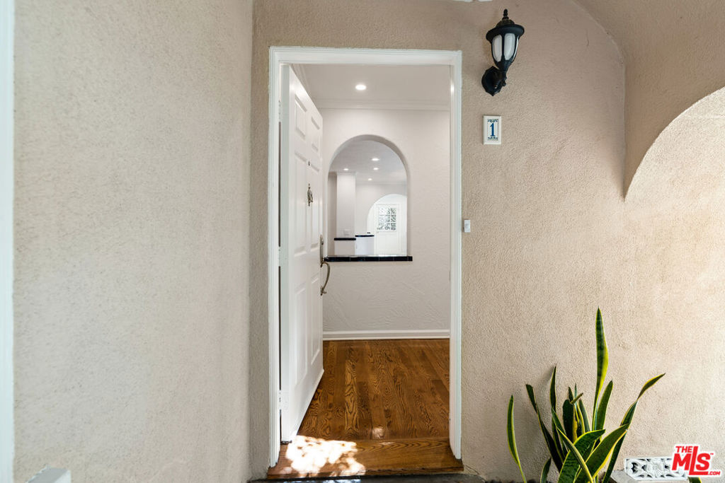 Spanish charm with a modern flare! This 3-bedroom, 2-bathroom light & bright lower unit has everything you need + it's steps from the trendy Melrose Place/Melrose Avenue for great shopping, eating & the great farmer's market! Gated entry & lush courtyard leads you to what feels like a home with an open flow to the living room, dining area & kitchen. Enter to the private patio area from the kitchen & primary suite. Hardwood floors in the entertaining areas, LED recess lights, central AC, alarm system, window treatments, custom closets & more (currently light grey carpet in bedrooms NOT the color in pictures)! Gourmet kitchen with stainless steel appliances, stackable in-unit washer/dryer + 2 tandem parking spots (1 inside garage & 1 outside of garage.) French doors in the living room & primary with retractable screens. Community barbecue, fireplace & outdoor dining area in the back of the building. 3-building complex surrounded by tranquil fountains, trees & manicured grass + easy to reach property manager. Building is secure. Truly one-of-a-kind building! Come Check It Out!