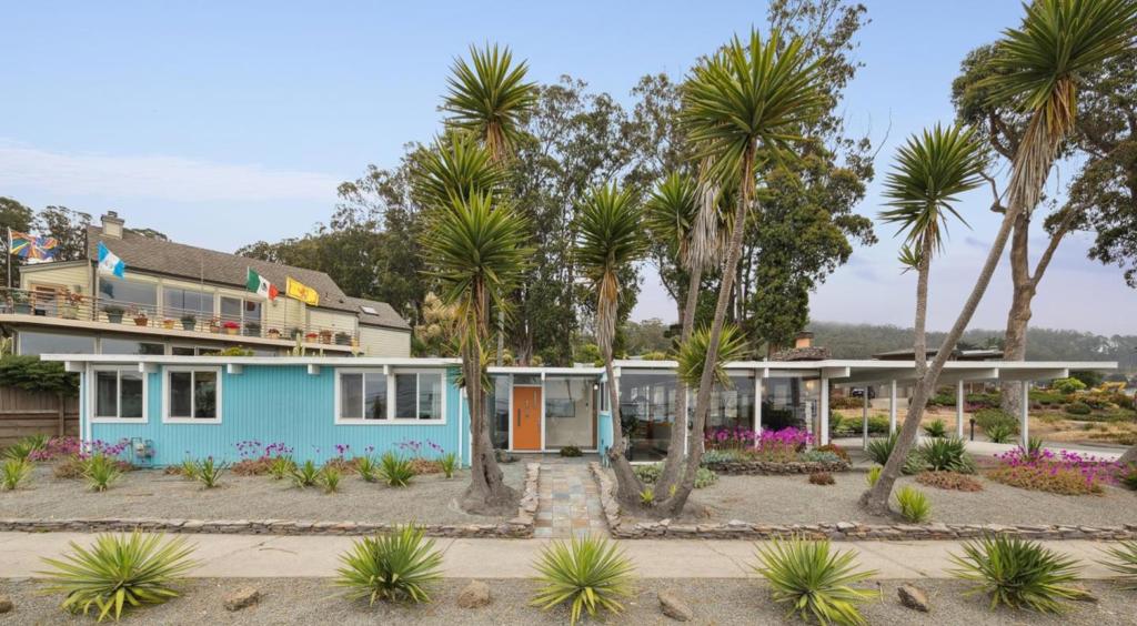 Experience coastal living at its finest in this spectacular single-level Eichler-style beach house, showcasing breathtaking ocean views and timeless mid-century modern design. This updated 3-bedroom, 2-bathroom home offers approximately 1,350± sqft of light-filled living space, thoughtfully designed with an open-concept layout, dramatic floor-to-ceiling windows, and signature post-and-beam construction. Stylish flooring, radiant heated floors, and room-by-room climate control create a warm and energy-efficient environment. The kitchen is a chef's dream, featuring granite countertops and ample cabinetry. The primary suite includes a beautifully tiled stall shower, while the hall bath features a custom cedar alcove and an extra-deep soaking tub. Skylights and open-beam ceilings enhance the home's natural ambiance while sliding doors lead to a deck ideal for outdoor dining, entertaining, or simply enjoying the coastal breeze. Ideally located in sunny El Granada known for its warmer microclimate this home is just a short distance to Surfers Beach, the Coastal Trail, Princeton Harbor, and Quarry Park. Easy access to Hwys 1 & 92 for all your Bay Area commutes. Offering the perfect blend of California architecture and modern amenities, this home is a rare gem on the coastside!