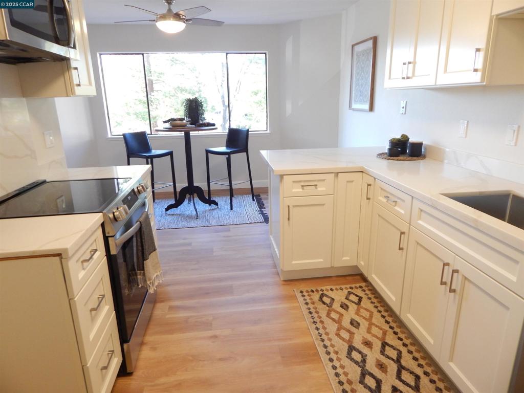 This unit has had a total remodel. New cabinets with soft closing doors and quartz countertops. Both bathrooms have new tub and showers with easy care quartz stalls, new hardware, plumbing and toilets. Beautiful new LVP flooring and carpets through out. This is almost a completely new unit. One of the best locations in the entire complex. Close to parking space, close to entry, secluded with no neighbors able to look into any window, with large redwood trees for shade and privacy. Come out today you will not be disappointed. Unit qualifies for HICAP financing which may pay for closing costs or interest rate buydown for qualified first time home buyers.