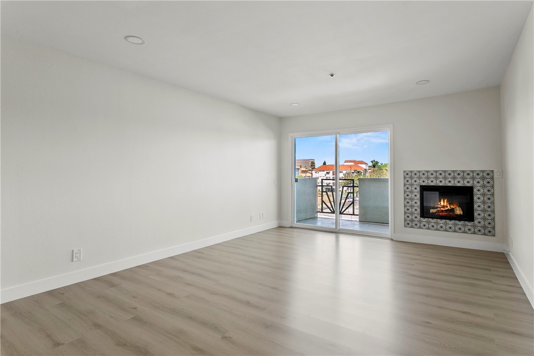 Welcome to urban living at its finest! This beautifully remodeled 1-bedroom condo is located in the highly sought-after Spectrum community, right in the vibrant heart of Downtown Santa Ana's Historic District. Just steps to Downtown Plaza, trendy coffee shops, and popular eateries—and only minutes from the 5 Freeway—this location offers unbeatable convenience and lifestyle.
Inside, you’ll find brand new wood-style vinyl plank flooring, a stunning remodeled kitchen with white shaker cabinets, quartz countertops, stainless steel appliances, and a breakfast bar perfect for casual dining or entertaining. The spacious living area features an electric fireplace with designer tile, recessed lighting, and a large sliding glass door that fills the space with natural light. Plus, enjoy central air!
Additional upgrades include all-new dual-pane windows and sliding door, an updated bathroom with custom linen cabinetry, and a generous walk-in closet in the bedroom. Storage is no issue with an entry closet, bathroom cabinetry, and walk-in bedroom closet providing ample space.
Enjoy secure, gated access to the community with amenities including a sparkling pool, playground, on-site coin-op laundry, and two dedicated parking spaces in the gated subterranean garage.