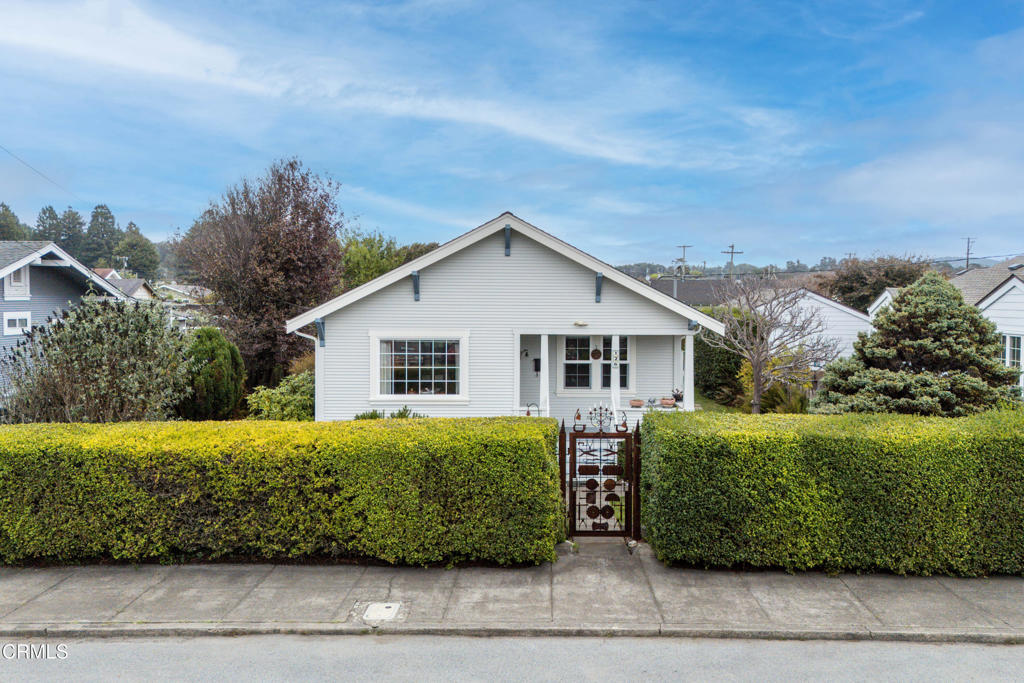 Tucked away on a quiet street in the heart of downtown Fort Bragg, this delightful home offers the perfect blend of character, craftsmanship, and convenience. Surrounded by a sweet garden and just minutes from shops, restaurants, and the ocean, it's the kind of property that feels instantly welcoming. Inside, you'll find quality touches throughout including custom fiddleback maple kitchen cabinets and imported tile from Corton, France. The hardwood floors, made from 3/4-inch maple, flow seamlessly through the kitchen and dining areas, creating a warm and timeless aesthetic. The primary bedroom features beautiful custom built-in cabinetry, adding both function and style. There's a wine cellar or storage area beneath the house, and an attic offering even more space for storage or creative use. The garage, accessible from the alley, houses a laundry room, one-car parking, and a workshop area  with excellent potential for conversion to an ADU or studio. Outdoors, enjoy a lovely concrete patio perfect for entertaining or relaxing, surrounded by landscaped gardens that provide beauty and privacy. Move-in ready and full of thoughtful upgrades, a turnkey home that perfectly balances modern living with small-town charm.