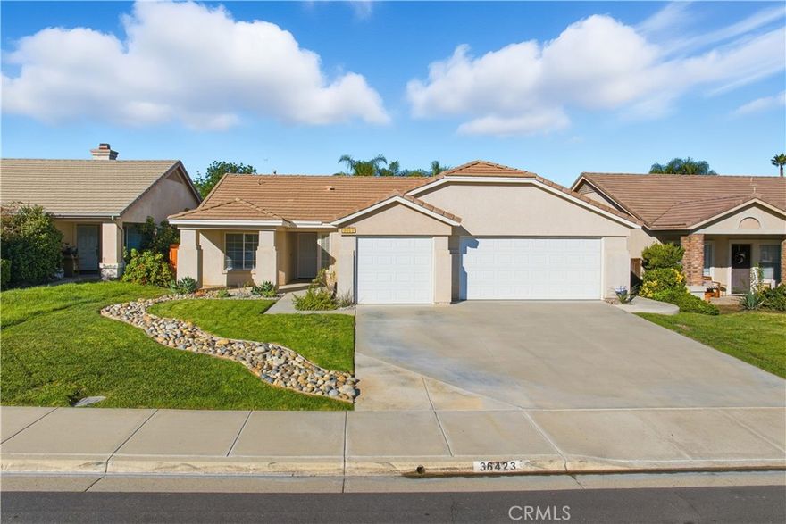 Single Level French Valley Charmer that is Move in Ready!  The covered front porch entry leads you to this 1491 Sq. ft home w/ 3 Bedrooms; 2 on one side & the primary bedroom on the other side, plus 2 full baths.  Tile flooring (carpeting in the bedrooms), tall ceilings, crown molding & ceiling fans all throughout the property.  The kitchen has granite countertops, a center island, bar top seating, stainless appliances, pantry & a cozy dining space.  The tall windows & Lg Slider in the living room allow you to have a great view of the backyard + there is a gas fireplace to enjoy on those chilly days.  The primary bedroom suite has dual sinks in the bathroom, soaking tub & separate shower + walk in closet.  The indoor laundry room leads out to the very roomy 3 car garage w/ space for 2 cars & all your other storage needs.  The backyard has a loads of shade w/ an expansive covered patio cover + loads of grassy space + a built in fire pit.  Plenty of room for a pool or kids play space! This home is perfect for someone looking for a first home with a yard or someone looking to downsize.  Close to all the new development happening in Winchester or just minutes away from all Temecula has to offer.  Low taxes and very low HOA.  Come see this one ASAP!