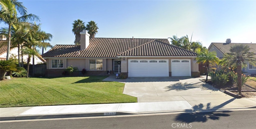 More photos and virtual staging photo renderings added! Enjoy Oceanside coastal living in this beautiful single level home in Guajome Meadows! This home offers a spacious, low maintenance, private backyard designed for both relaxation and entertainment. A natural gas stub out is in the southwest corner of the yard, perfect for connecting a natural gas BBQ. A cute accessory storage shed integrated with the landscaping offers extra storage in addition to the room already provided in this home's three car garage which has several storage cabinets and a built in work bench. The beautiful kitchen features dark cherry finish cabinets, granite countertops, stainless steel appliances, and a garden window for placing potted herbs! The kitchen opens to the open concept family room/dining room combination, which allows the chef to conversate with guests easily. The engineered wood floors from the family room/dining room extend to the west wing hallway which provides access to the master bedroom, two guest bedrooms, a hallway bathroom, and the utility/laundry room. The master bedroom has an ensuite bathroom complete with a remodeled shower and a walk-in closet. Both the master bathroom and hallway bathroom feature the same matching cherry finish cabinets. An inviting living room and entry way greet visitors to the home. The living room features a fireplace and a built-in dry bar - with matching cherry finish cabinets and granite countertop. A fourth bedroom and ensuite bath is accessed from the living room. The roof was redone in 2020 and the air conditioning system was replaced in 2019, according to public records. Photos with furniture are virtually staged photo renderings.