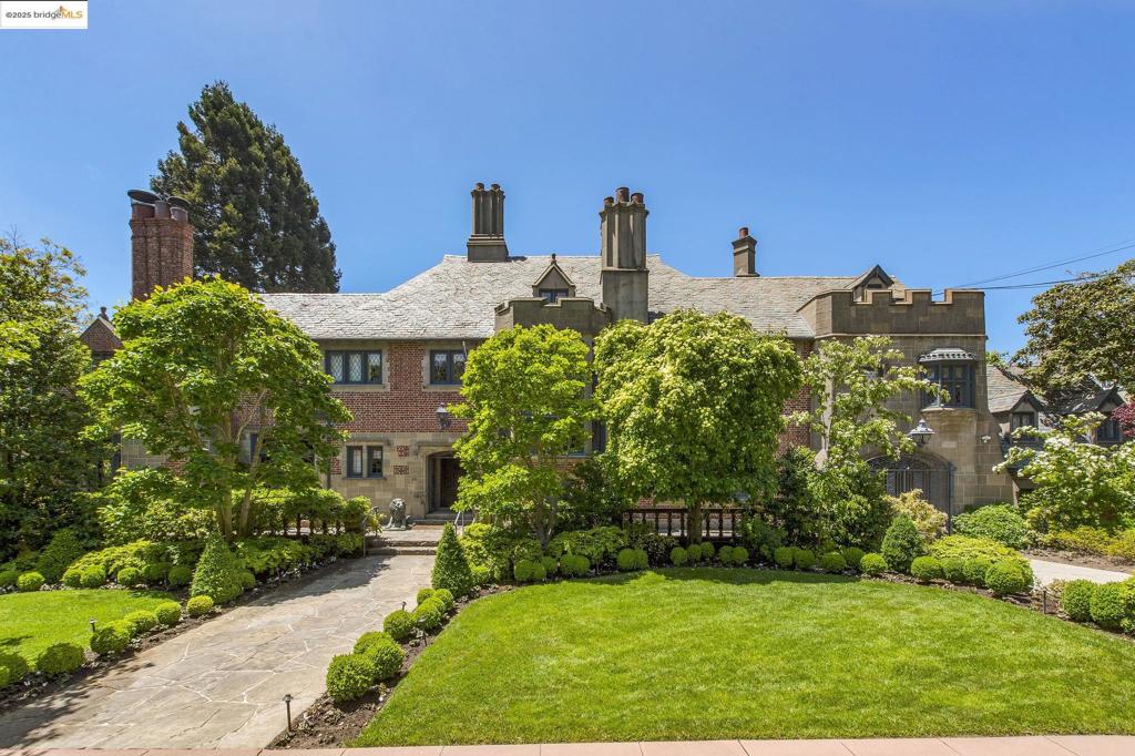 Welcome to this stunning house, a true architectural gem designed in 1930 by the renowned duo of Albert Farr and Francis Ward. This magnificent Tudor features a red brick façade with a two-story large, angled bay window with leaded glass adding a touch of grandeur and character to the home. The inside has been meticulously remodeled from top to bottom, boasting beautiful finishes throughout. The spacious living room features ornate plaster moldings on the ceiling and elaborately carved bookcases and mantel. The dining room is richly paneled and has a coffered ceiling leading to a beautifully appointed kitchen with no detail left undone. This magnificent house spans across four full levels with a total of six bedrooms, seven full baths, and three half baths. The lower level features a ballroom complete with a caterer’s kitchen that can easily accommodate any event or gathering. Outside is a lushly landscaped yard with a sparkling pool and outdoor entertainment areas to provide the perfect setting for guests or relaxing. Located in central Piedmont on one of the most coveted streets, this home has easy access to top-rated schools and all the Piedmont has to offer.