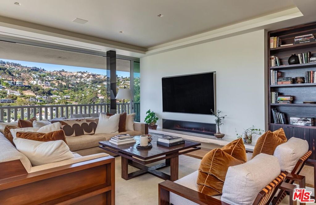 Step into one of the most refined residences in the legendary Sierra Towers. This impeccably renovated two-bedroom, three-bathroom corner unit boasts unobstructed views of the city skyline, rolling hills, and the Pacific Ocean - best enjoyed from an expansive, private terrace. A dramatic double-door entry reveals an open-concept living and dining area, perfect for both intimate gatherings and grand entertaining. The gourmet kitchen is outfitted with top-of-the-line appliances and custom finishes. The hallway leads to an opulent primary suite featuring a luxurious spa-like bathroom and ample closet space, while a spacious second en-suite bedroom provides comfort and privacy for guests. Located in one of Los Angeles' most exclusive full-service buildings, residents enjoy 24-hour security, valet parking, a resort-style pool, state-of-the-art fitness center, and unparalleled privacy. A rare opportunity to own a sophisticated sanctuary in the sky.