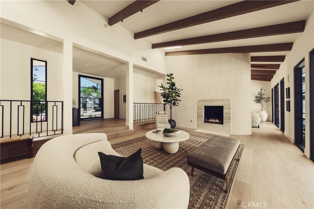 Welcome to this stunning, sprawling residence in the Hills of Encino, offering timeless, luxurious design and exceptional craftsmanship.
From the moment you arrive, the smooth stucco façade with limestone accents delivers striking curb appeal. Travertine steps lead you to an impressive ten-foot glass entry door, setting the tone for what awaits inside.
The foyer is bathed in natural light, thanks to multiple iron French doors and strategically placed skylights. The great room is anchored by an expansive fluted architectural fireplace, creating a sophisticated, inviting ambiance. Throughout the home, premium finishes, including French oak engineered hardwood flooring.
A massive living room faces the backyard seamlessly flows into the chef’s kitchen, highlighted by a large island with fluted wood paneling, abundant white oak cabinetry, top-of-the-line Thermador appliances, and a walk-in pantry for added convenience. Adjacent to the kitchen, a private family room offers a cozy retreat separate from the main entertaining areas.
A central hallway leads to two bedrooms, a formal dining room featuring a built-in wine rack, a stylish bathroom, and a utility room with laundry facilities.
In the southern wing, you’ll find two en-suite bedrooms and the expansive primary suite overlooking the backyard. The primary bathroom is a showstopper, with dual showers featuring travertine checkered floors, limestone flooring, and a custom dual vanity topped with Arabescato Corchia marble. The custom walk-in closet provides generous storage and organization.
The low-maintenance backyard is perfect for entertaining, with travertine flooring throughout, a large pool and spa, built-in barbecue, and integrated speakers. An additional spacious side yard features a pergola-covered patio with peek-a-boo views. For added convenience, there is an additional bathroom with access from the side yard for those using the pool.
This home offers a luxurious, timeless aesthetic sure to impress, all within close proximity to the best shopping and dining the Valley has to offer.
