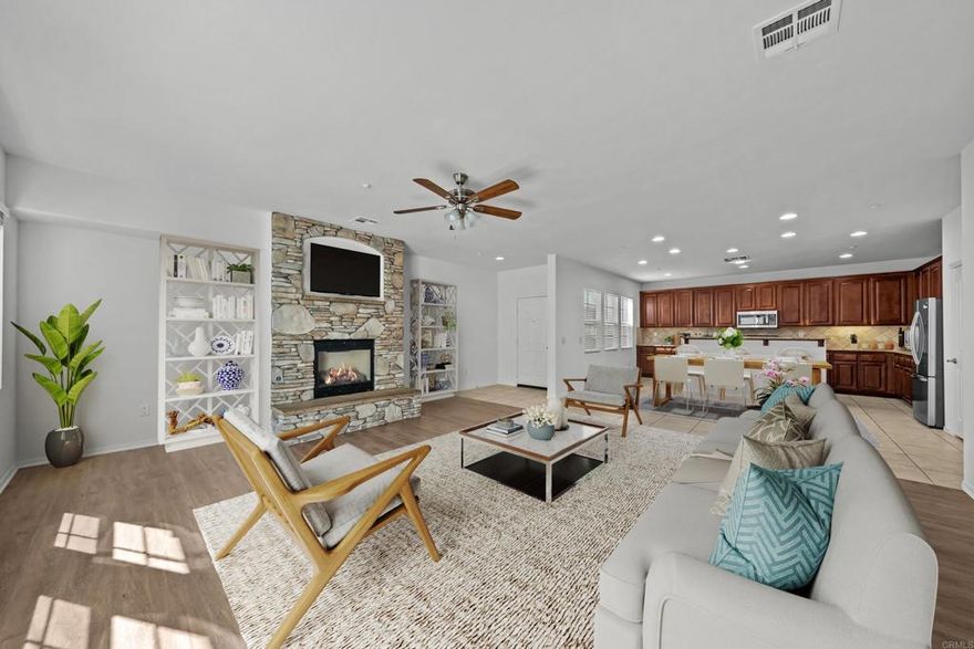 Move-in ready, this turnkey townhome offers a bright, open layout and a prime location near Temecula Valley Wine Country. New hard-surface flooring in the living room and bathrooms, new carpet on the second level, fresh paint and new blinds throughout, and new ceiling fans in nearly every room. An open-concept main living space overlooks the dining area and kitchen with a custom stone fireplace and direct access to the private outdoor patio. The kitchen boasts stainless appliances, including a new refrigerator, granite counters, tile backsplash, abundant cabinetry, walk-in pantry, and a center island with breakfast bar. The primary suite features a large walk-in closet with custom organizers and an ensuite bathroom with dual vanity, jetted soaking tub, and separate walk-in shower. Two additional bedrooms, full bath, and convenient upstairs laundry room complete the second level. An attached two-car garage provides direct access and additional storage space. Community amenities include a pool & spa, playground, and Sheffield Park is just a short walk away. Located within the Temecula Valley Unified School District and close to shopping, dining, and local wineries. Enjoy the best of Southern California living with nearby hiking trails, fishing, lakes, conservation areas, hot springs, and more.