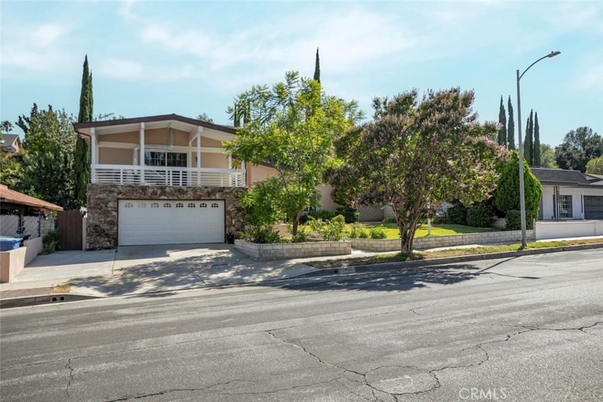 Welcome to an exquisite retreat located in the serene and prestigious neighborhood north of Rinaldi in Granada Hills. This breathtaking 2,532 sq ft home, with four bedroom and three bathrooms.From the moment you arrive, the home commands attention with its striking solid wood double entry doors, setting the stage for a residence filled with refined elegance. Recent renovations ensure a turnkey experience, including energy efficient dual-pane windows.The private oasis at the rear is a masterclass in outdoor design, featuring a reinvigorated pool with new plaster, tiles, and ambient lighting. Stamped pavement encircles the pool, leading to a chic pergola and an array of trees, creating a perfect backdrop for entertainment or relaxation.

Step inside to discover a home that radiates sophistication and warmth. The interior boasts fresh paint and new laminate flooring across the communal areas, including a stunning kitchen that serves as the heart of the home. Here, quartz countertops, cherry wood cabinets, and a center island invite culinary exploration. The master suite is a haven of comfort, complete with a private bathroom and an inviting balcony offering serene views.

This home is not just a place to live; it's a lifestyle choice. With copper plumbing, every detail has been curated for comfort and peace of mind. The attached two-car garage provides convenient home access, underscoring the thoughtful design of this magnificent property.

Situated in a neighborhood known for its tranquility and proximity to natural beauty spots like O'Melveny Park and Bee Canyon, this home also offers easy access to freeways, shopping, and dining. Your dream of upscale living in Granada Hills is within reach. Discover the perfect blend of style, comfort, and convenience in this magnificent home.
