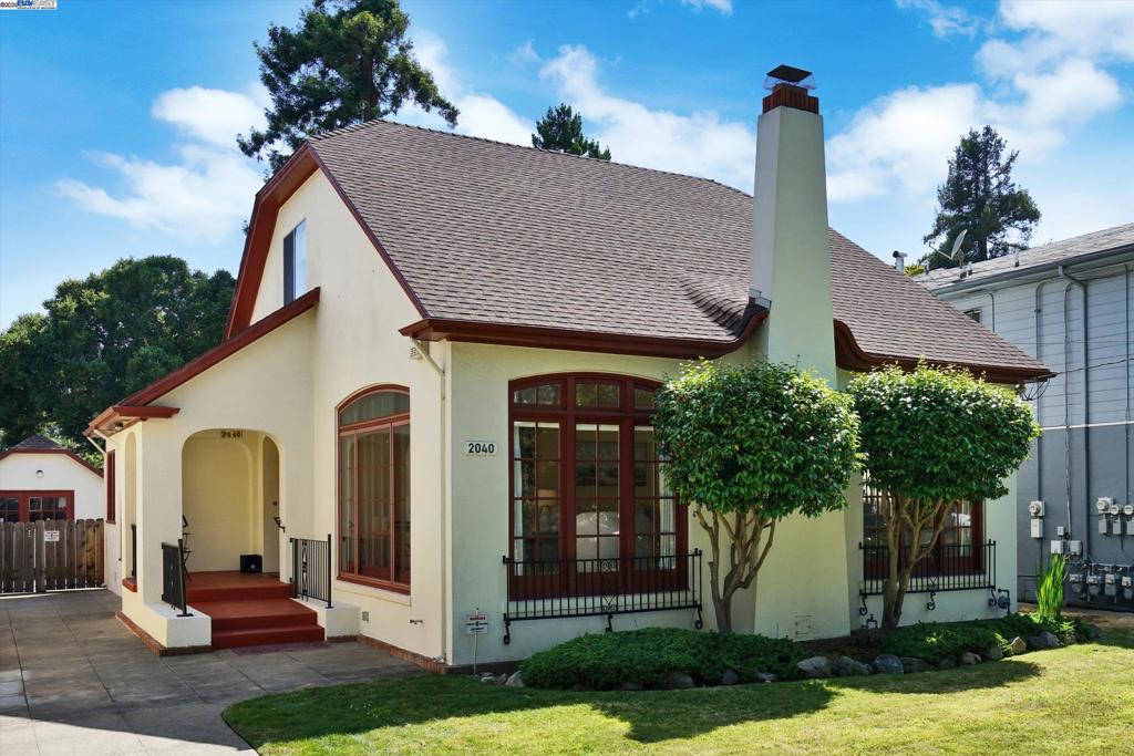 Storybook Charm with Voluminous Rooms + Expansion Potential on an Oversized Alameda Lot = Your Dream Home. Tucked behind a lush lawn with mature foliage and a long driveway, this 1920s English Cottage–style gem is a rare find. With 1,846 sq ft on a huge 7,000 sq ft lot, it offers character, space, and potential. Step inside the show-stopping living room with a barrel-vaulted ceiling, fireplace with detailed surround, and large picture windows that flood the space with light—like your own vintage ballroom. Generously sized rooms create a gracious, welcoming atmosphere that invites you to relax and feel at home. Original hardwood floors have been professionally resurfaced, and period details like coved ceilings and wood trim enhance the charm, while a newer furnace and central AC provide modern comfort. The traditional layout includes a formal dining room and cozy breakfast nook. The kitchen & bath retain their vintage appeal and present an opportunity to customize. Legally a 2-bed, 1-bath, the home also includes a generous upstairs space—currently a 3rd bedroom—with potential for a luxe primary suite. The detached garage offers ADU potential, with possible room for another in the deep backyard. Restore, expand, or enjoy as-is—this Alameda home is ready for your next chapter.