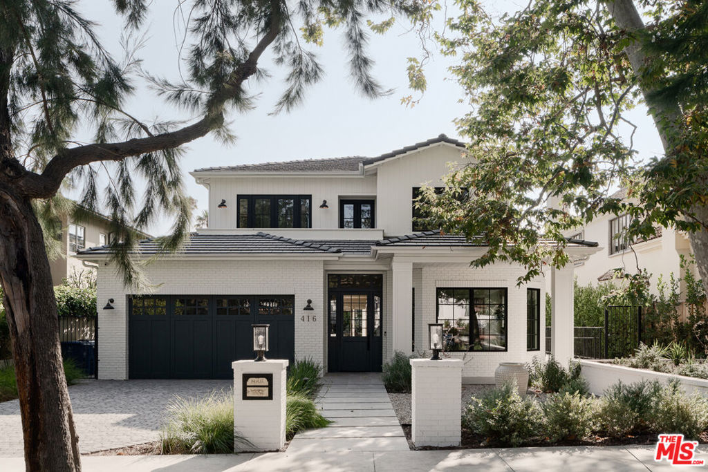 Experience the allure of this modern traditional home, where an abundance of natural light fills every corner and soaring 10-foot ceilings enhance the ambiance throughout. The seamless indoor-outdoor flow creates an ideal setting for family living and entertaining, further enriched by a dedicated home theater and an exquisite wine cellar. With a convenient elevator, accessibility is a key feature, making every level of this home easily reachable. The kitchen is a chef's dream, showcasing breathtaking marble countertops, an expansive island, double ovens, and top-of-the-line appliances. The generously sized primary suite features vaulted ceilings, a cozy fireplace, and French doors that open onto a charming terrace. A custom walk-in closet adds an extra layer of sophistication.Nestled among lush greenery, this property offers ultimate privacy, making it a serene retreat. Enjoy the perfect blend of luxury and comfort in this exceptional home.