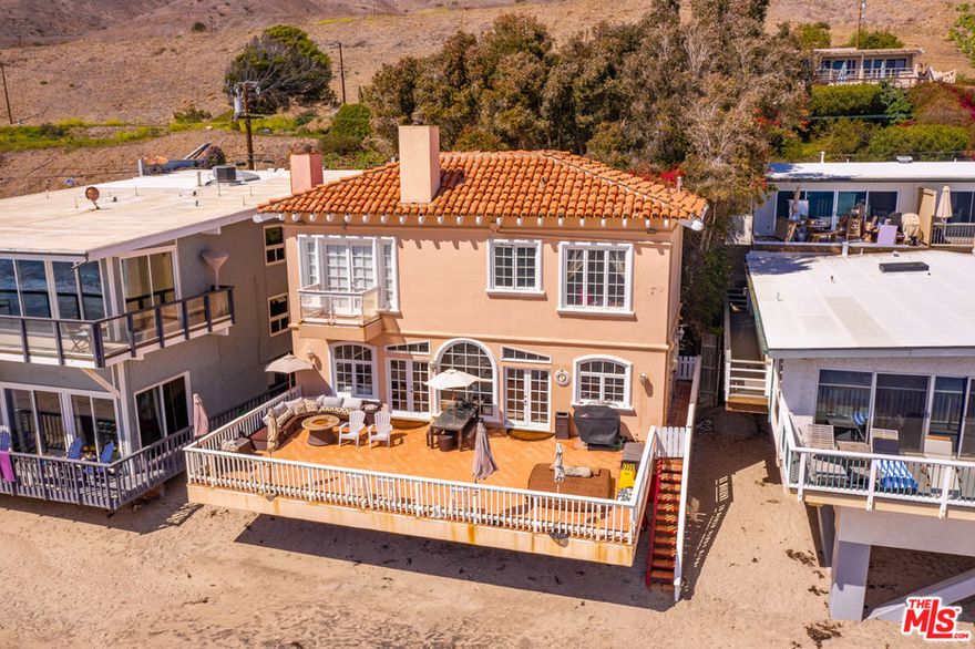 Active and Available.  Weekday showings from 10 to 3 with 48 hour notice.  Wide sandy beach, wide waterfront deck, wide front parking off street behind the wide ticket line!   Tuscan style two story with open concept.  French doors from living and dining area to outdoor ocean front play deck. Living room and primary suite have fireplaces.  Downstairs den with built in shelving and seating.  High ceilings.  Upstairs are 3 bedrooms.  Primary en suite also has ocean facing balcony.   Lush landscaping in deep private courtyard.  2 car detached garage. Long time tenant currently in place, month to month lease. Please do not disturb occupant