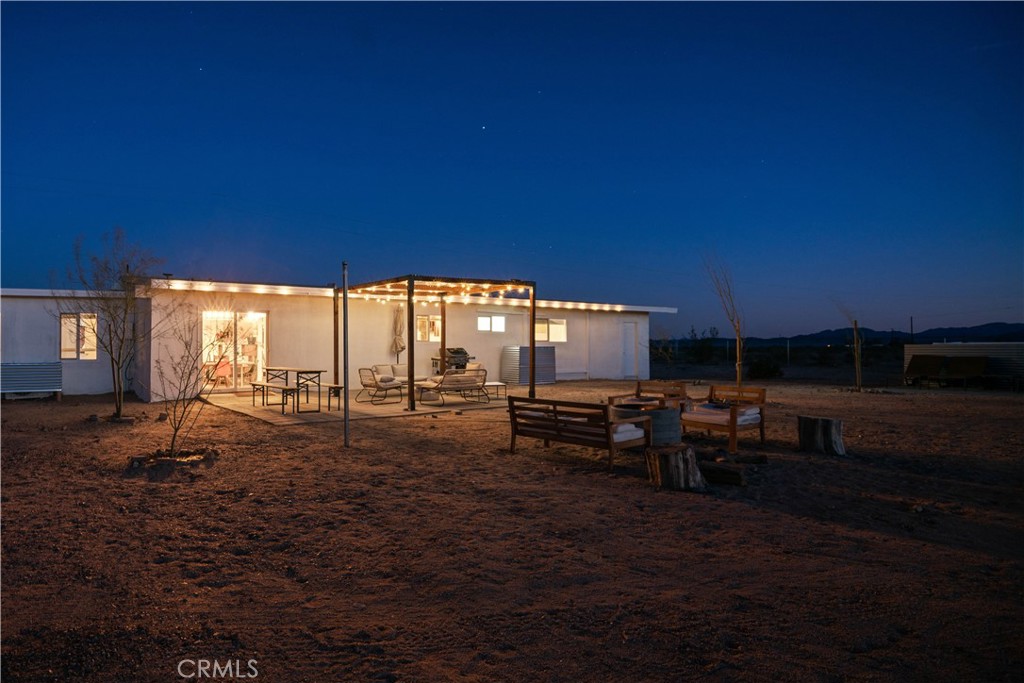 The high-desert high-life in Wonder Valley. This desert modern residence sits on 5 expansive acres and offers the perfect blend of contemporary design and rugged natural beauty. The swank of a low desert getaway with true Mojave wilderness at your doorstep.
Indoor/Outdoor living with spa, fire pit, pergola for shade. Soak in the breathtaking scenery while enjoying the comforts of home. You're 20 minutes from the JT National Park North entrance and a quick drive into downtown 29... with an emerging culinary and cocktail scene that will satisfy you and your guests on those off campus excursions. Views are astounding. Wide open government owned land all around. Views deliver perfectly framed sunrises and sunsets with mountain backdrops.
Home is on hauled water and septic. Well can be installed for about $30K.
This location is a stargazer's paradise, dark sky territory offering unparalleled views.
Inside, you'll find a great floorpan in a spacious 3 bedroom, 2 bathroom home that delivers style and comfort.
This property is eligible for both Community Lending and Homerun Discounted loan programs. Both programs allow for up to 1.5% off the interest rate and can also include No PMI.