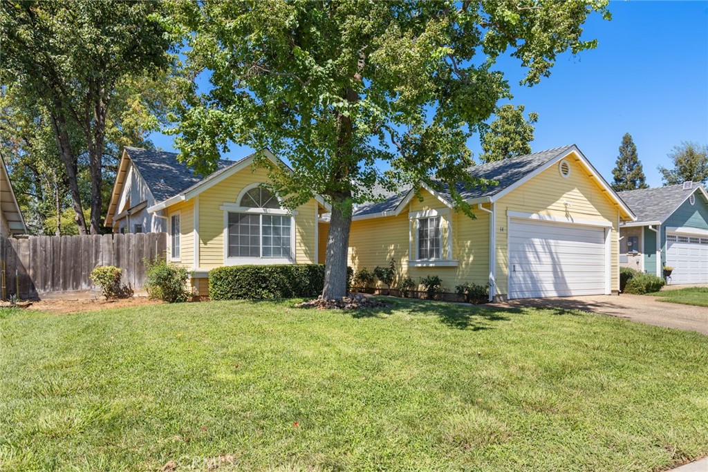 Tucked away in a quiet and welcoming North Chico neighborhood, this delightful home is the perfect blend of charm, comfort, and functionality. With 3 bedrooms, 2 bathrooms, and 1,374 sq. ft. of thoughtfully designed living space, it offers everything you need to feel right at home. Step through the front door and you’ll be greeted by a bright and open floor plan featuring beautiful laminate flooring, soaring vaulted ceilings, and soft, neutral paint tones that create a warm and inviting atmosphere. The spacious living room is a true focal point, offering plenty of room for gatherings and a cozy brick fireplace that adds a touch of character while making it the perfect place to curl up on cooler evenings. The kitchen is as cute as it is practical, designed to bring out your inner chef. Outfitted with tile countertops, ample cabinetry, a dishwasher, an electric range, and a breakfast bar for quick bites or morning coffee, it’s a space where function meets charm. Just off the kitchen, the dining area provides the ideal setting for both casual family dinners and more intimate get-togethers with friends. When it’s time to unwind, the primary suite delivers just the right balance of space and comfort. With its generous layout, nicely sized closet, and private en suite bathroom featuring a large vanity and a walk-in shower, it’s a peaceful retreat you’ll look forward to at the end of each day. Two additional guest bedrooms provide plenty of options—whether you need extra sleeping space, a home office, or a cozy den. Additional highlights include ceiling fans throughout, a separate indoor laundry room for added convenience, and a large two-car garage with plenty of storage potential. Outside, the backyard offers a quaint patio area for weekend barbecues, a stretch of lawn perfect for pets to roam, or simply a quiet spot to enjoy your morning coffee. The location couldn’t be better nestled in a desirable neighborhood and close to shopping, dining, schools, and a short drive to Bidwell Park, you’ll love both the home and its surroundings. Whether you’re a first-time buyer or simply searching for a cozy yet spacious place to call your own, this property checks all the boxes. Don’t let this wonderful opportunity pass you by!