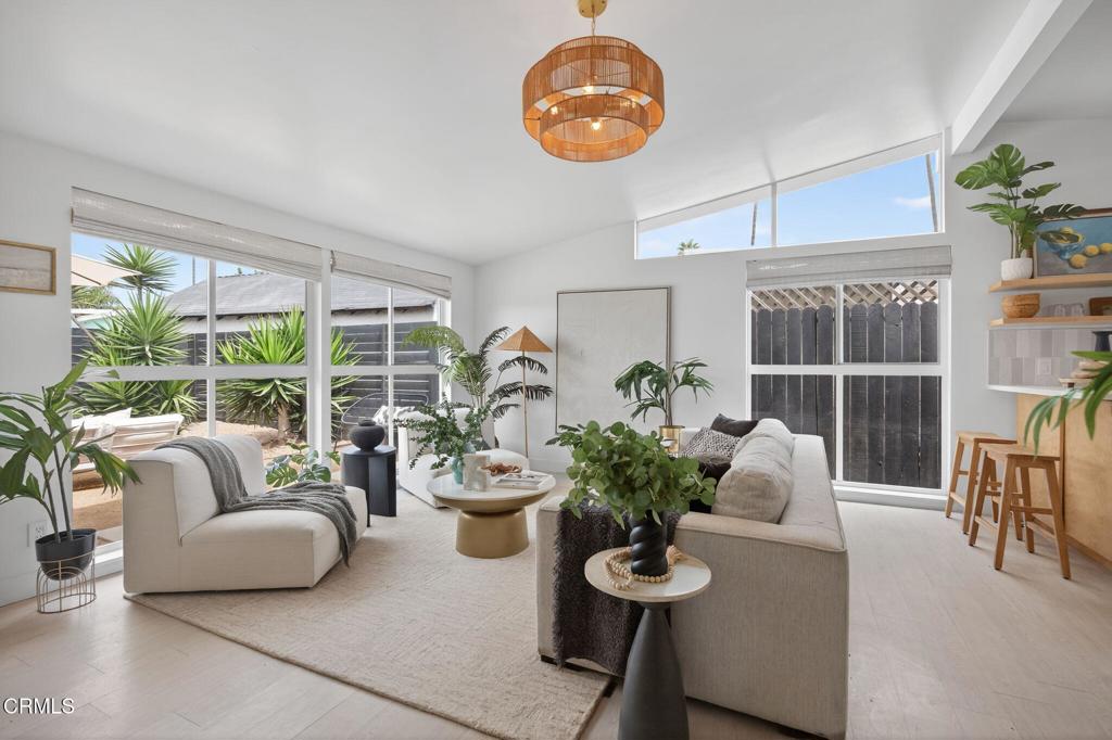 A rare opportunity to own a midcentury jewel-box home just steps from the sand in Ventura's coveted Pierpont Lanes. Nestled within a private compound of front and back gardens, the architectural design blends timeless style with an easy, relaxed coastal vibe. Numerous living and lounge spaces invite both connection and solitude: mornings on the front patio after a swim, evenings gathered for alfresco dining on the back terrace, sunset drinks on the roof deck, or quiet conversation by the fire pit. The open plan offers a seamless flow between rooms and a feeling of ease that suits everything from weekend entertaining to laid-back beach days. Though noted at 1,148 sq ft, the three-bedroom, one-bath residence lives far larger, thanks to abundant natural light, thoughtful sightlines, and generous bonus areas. A dramatic living room framed by walls of glass, an inviting den, and a finished garage with privacy glass door reimagined as a media or studio lounge create spaces to gather, work, or unwind. At the heart of the home, the kitchen is a study in refined coastal simplicity. Warm custom wood cabinetry integrates soft-close drawers and a deep pull-out pantry, while glass or open uppers keep the room airy and bright. Honed white-cement counters and new stainless appliances bring a fresh yet timeless personality, with subtle notes of Australian-coastal design that make the space equally suited to casual breakfasts or evening cocktails with friends. The bathroom channels the quiet luxury of a Moroccan spa, finished in smooth hand-troweled microcement with a generous walk-in shower and artisanal cabinetry. Throughout the house, bespoke built-ins and discreet storage solutions maintain clean lines and preserve the integrity of the architecture. Outdoors, the property unfolds as a series of serene destinations. Minimalist landscaping in decomposed granite and modern plantings sets a calm, contemporary tone in both the fenced front court and the private rear garden. A covered dining patio invites leisurely meals, while an outdoor tiled shower--with hot and cold water plus a foot sprayer--makes rinsing off after the beach effortless. Above it all, a freshly painted roof deck offers a front-row seat for sweeping sunsets. A new driveway with parking for four completes this move-in-ready coastal retreat, offered turnkey and available furnished for those seeking an immediate embrace of midcentury beach living.