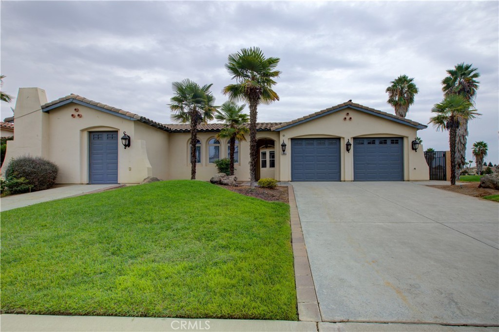 Located in the gated Greenhills community of Chowchilla, this Spanish-style home sits right on the golf course and offers 3 bedrooms, 2.5 bathrooms, and 2,680 sq. ft. of living space. A private front courtyard leads to a spacious interior with fresh new carpet in the bedrooms and living room. The kitchen features a large island, granite counters, and stainless steel appliances - perfect for cooking and entertaining. The primary suite includes a fireplace, two walk-in closets, dual vanities, a jetted soaking tub, and a separate shower. One of the secondary bedrooms even has its own private entrance from the front of the home, ideal for multi-generational living or a home office. Additionally, the home includes a two-car garage plus a separate golf cart garage, and the backyard offers beautiful views of the golf course. Enjoy the privacy of a gated community and the ease of living right on the course - perfect for morning rounds and sunset views from your backyard.