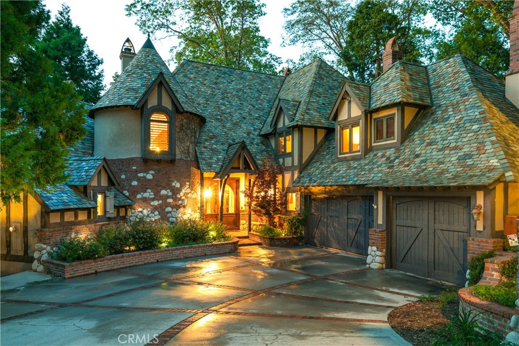 Nestled in prestigious gated Cedar Ridge, this exceptional Mountain Lodge, crafted by the Ron Dolman, exemplifies unparalleled craftsmanship and timeless elegance. Designed to harmonize with its natural surroundings, the residence features a distinctive slate roof, adding to its rustic charm.
Upon entering through the custom-built double doors, you're greeted by soaring vaulted ceilings that create an immediate sense of grandeur. The open-concept design seamlessly connects the dining area, a chef-inspired kitchen, and a cozy family room, making it ideal for both intimate gatherings and large entertaining.
A rare find, the main-level master suite offers privacy and convenience. French doors open to expansive decks providing a tranquil retreat. Through the trees, a filtered lake view adds to the room's serene ambiance.
Ascending the sweeping solid oak staircase leads to four generously sized bedrooms, each accompanied by its own private en-suite bathroom. This thoughtful design ensures comfort and privacy for all.
The lower level is designed for leisure and entertainment, featuring a spacious game room complete with a wet bar. A full bathroom and a substantial storage room add to the functionality of this space.
Catering to outdoor enthusiasts, the property includes an RV/boat garage equipped with a workbench. Additional parking accommodates at least seven vehicles, including boats and RVs, ensuring ample space for all your recreational needs.
A spacious office located below the RV garage, accessible via dual entries, offers a quiet workspace, ideal for remote work or study.
Surrounded by majestic cedar trees and the tranquility of nature, the home emphasizes indoor-outdoor living. Multiple decks invite relaxation and provide the perfect setting for enjoying the serene environment.
Offered fully furnished, the property includes all fine furniture and decor, allowing for a seamless transition into this mountain sanctuary.
This residence is a rare gem, combining luxurious amenities with the natural beauty of Cedar Ridge, offering an unparalleled mountain living experience.