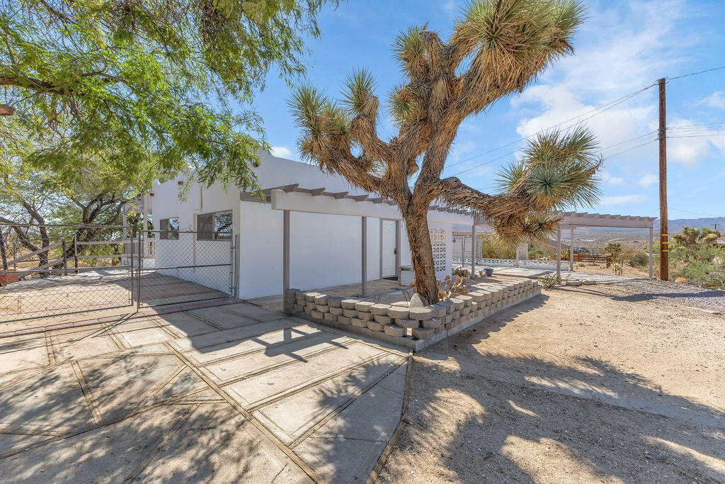 Discover this charming 2-bedroom, 1-bath home set on 1.38 acres in a sought-after Yucca Valley location. With its Pueblo-style character and cozy wood-burning stove, this home is perfect for families looking for comfort and space to grow. An unfinished multi-purpose room is ready for your vision--create a playroom, den, or additional living area to suit your needs. Step outside to truly appreciate the lifestyle this property offers: a large deck with an additional pergola area for gatherings, a chicken coop, and plenty of space for horses, pets, or your dream garden. Multiple vehicle access points add everyday convenience, while breathtaking mountain and desert views create a peaceful backdrop for family living. Currently an active short-term rental, this property also offers strong income potential. Whether you're searching for a welcoming family home or a desert retreat with room to roam, this property blends charm, functionality, and outdoor enjoyment.