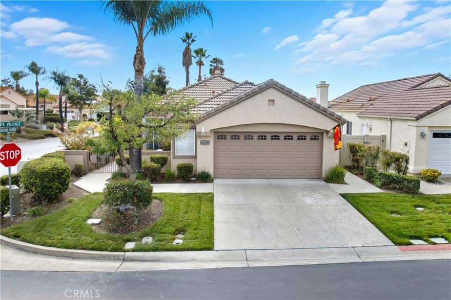 Welcome to 24165 Corte Valente, a beautifully maintained 2 bedroom, 2 full bath, single-story home in Murrieta’s desirable Colony community with an office area that can also serve as a 3rd bedroom. This residence blends open-concept living, thoughtful upgrades, and serene outdoor spaces to create an inviting atmosphere perfect for comfort and entertaining. From the moment you enter, you’re greeted by an open and airy floorplan with vaulted ceilings that enhance the sense of space and natural light. The seamless flow between the living room, dining area, and kitchen encourages both relaxation and connection, making it ideal for gatherings or quiet evenings at home. The tile flooring throughout the main living areas adds durability and elegance, while laminate wood-style floors and plush carpet in select spaces provide warmth and comfort. The upgraded kitchen is the heart of the home, featuring granite countertops, a center island, stainless steel appliances and rich oak cabinetry that offers both style and functionality. Whether preparing meals or entertaining guests, the layout provides ample counter space and easy access to the dining and living areas, maintaining an effortless flow throughout.

The primary bedroom is spacious w vaulted ceilings and the primary bathroom includes dual sinks and a walk-in closet. A flexible room off the main living space currently serves as an office or den but can easily be used as a third bedroom to accommodate guests or additional family needs. The home’s vaulted ceilings and abundant natural light create an open, inviting feel in every room, complementing the carefully chosen finishes and design touches.

Stepping outside, you’ll find a private backyard oasis designed for enjoyment and tranquility. The landscaped, garden-like setting includes drought-tolerant plantings, mature fruit trees, and a covered patio ideal for outdoor dining or morning coffee. The backyard’s thoughtful design offers both beauty and low maintenance, while the open space beyond provides privacy and a peaceful backdrop. Located within the sought-after Colony community, residents enjoy access to resort-style amenities including a golf course, clubhouse, pool and spa, fitness center, pickleball and tennis courts, and numerous social and recreational opportunities. Corte Valente is a perfect combination of style, functionality, and comfort—an exceptional home that captures the best of Southern California living in a welcoming and vibrant community.