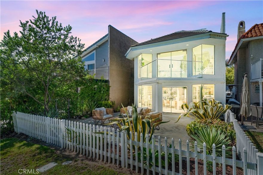 Welcome to this architecturally stunning home, designed and owned by a distinguished architect educated at the renowned USC School of Architecture. As one of the largest homes in the Lake Forest Keys, every detail was thoughtfully conceived to evoke a remarkable sense of light, space, and modern elegance.  Walls of custom glass and carefully curated sightlines frame the views with intention, inviting the outdoors in and enveloping the home in a luxurious aura of calm, light and space. The home has been recently refreshed with sophisticated new interior paint, designer lighting, and beautifully renovated bathrooms that blend modern elegance with timeless style.  The exquisitely updated kitchen is perfect for entertaining and features plenty of counter space and storage with two islands, a prep sink, and brand-new high-quality appliances.  A masterpiece of design, the primary suite features walls of custom glass highlighting panoramic lake vistas, integrating the natural light and reflections of the water into the home’s architectural rhythm, where the interplay of light and water creates a daily work of art. Glass doors open to a private terrace for an effortless connection to the serene outdoors.  Two additional upstairs bedrooms offer refined comfort for family or guests, while a substantial bright and open bonus space above the garage provides exceptional versatility—ideal as a secondary living area, media lounge, executive home office, or private guest suite. With its own exterior entrance, kitchenette, additional closet space,, and laundry hookups, this space also offers the potential for a fully self-contained ADU. Walk to the nearby community clubhouse at the Sun & Sail club which offers resort-like amenities including a private bar and lounge just for residents, a fully equipped indoor gym, multiple pools, a spa, and tennis, pickleball and other sports courts. If you are looking for an extraordinary home AND a quintessential Southern California lifestyle, this is it!