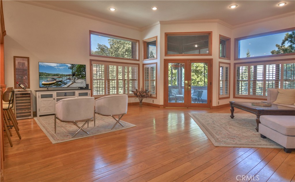 This stunning 3,064 square foot home in Lake Arrowhead sits on a spacious landscaped lot with full lake rights. It features 4 bedrooms and 4 baths, including a potential separate apartment. There is also an additional office/potential ADU with a bathroom. The property includes a 2-car attached garage and additional parking across the road. High ceilings and ample natural light complement the wood flooring throughout most of the home. Two fireplaces and large open spaces, this mountain retreat offers both elegance and comfort for relaxation and entertaining. With winter lake views and beautiful trees visible from both inside and the landscaped backyard, you can enjoy relaxing indoors, strolling outside, or sipping beverages in the enclosed garden room or in one of the many cozy atmosphere rooms making this mountain retreat truly special for entertaining and unwinding.