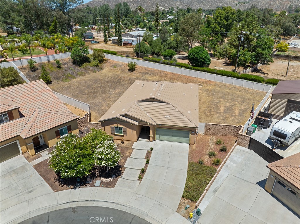This expansive single-story home sits on a rare .45-acre lot at the end of a quiet cul-de-sac, offering room for 3 pools and then some! Custom concrete walkway leads you up to this beautiful home featuring 4 bedrooms, 2 bathrooms, and a versatile flex space perfect for a 5th bedroom, home office, or formal dining room. Step into a great room layout with a spacious family room that flows into the chef’s kitchen, complete with a large center island, ample granite countertop space, and updated appliances. The primary suite overlooks the lush backyard and includes a step-in shower, dual sinks, and a generous walk-in closet. On the opposite wing, you’ll find three additional bedrooms, a full hall bath, and two storage closets. Gorgeous new flooring installed in 2023. HUGE potential RV access!!! Enjoy endless possibilities in the enormous backyard—whether it’s entertaining, gardening, or building your dream outdoor oasis. Low taxes and low HOA complete the package!