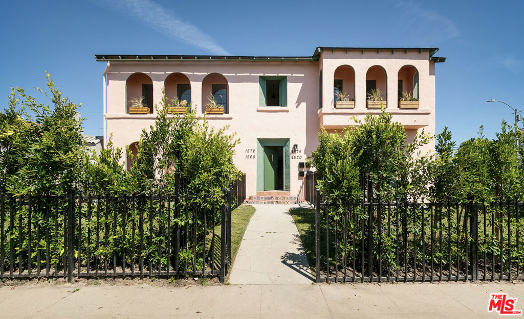 Discover the charm and grace of this thoughtfully renovated Spanish Colonial Revival, ideally situated on a light-filled corner lot. This oversized 2-bed, 2-bath residence blends timeless character with modern comfort in all the right ways. From the moment you arrive, the architecture enchants with arched windows and doorways, a warm stucco exterior, and a private front yard exclusive to the unit, offering the perfect balance of privacy and indoor-outdoor living. Inside, the sun-drenched open floorplan is rich with historic detailing and generous scale. The living room flows seamlessly into an expansive dining area, while the open kitchen features a central island, ample cabinetry, and a layout that nods to the home's original soul while embracing contemporary style. Both bathrooms have been tastefully updated with finishes that elevate the space without overshadowing its heritage. System upgrades include HVAC, a new roof, and permitted updates to electrical, plumbing, and foundation - all providing peace of mind and lasting value. Secure parking is included, and the location in Faircrest Heights - recognized as one of the "10 Best Districts You've Never Heard Of" by both Los Angeles Magazine and Business Insider. Surrounded by historic architecture and vibrant community life, this central hub is minutes from Beverly Hills, The Grove, Cedars-Sinai, La Cienega Park, and some of LA's best dining and shopping. This is a rare opportunity to own a piece of Los Angeles history - restored with intention and designed to inspire.