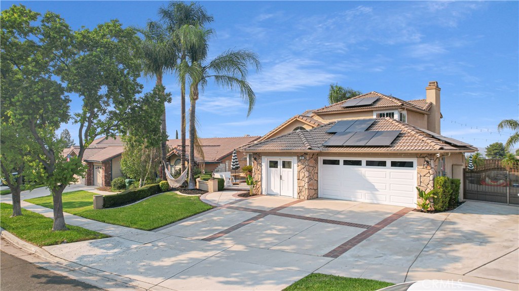Breathtaking home located in the community of South Corona. This magnificent 2-story Pool Home with RV Parking features an open layout that provides ample space for all your needs. Enter into the spacious living room with vaulted Ceilings and lots of natural lighting. There is a main level bedroom and a full bathroom perfect for guests. The Kitchen was recently remodeled and is breathtaking! Kitchen features lots of cabinet space, custom counters & backsplash, dedicated cabinet to hide your coffee maker, gorgeous appliances, hot water line above stove, recessed lighting and breakfast bar that flows into the family room with brick fireplace. Large Separate Dining Area for family meals that leads to the beautiful backyard with a stunning pool and spa, offering the perfect setting for outdoor gatherings and relaxation surrounded by luscious greenery. Upstairs features 2 spacious bedrooms and The extra large primary bedroom with panoramic views overlooking the scenic backyard and the city beyond creates a tranquil retreat within your own home. Laundry room located downstairs. Nearly 40 solar panels that provides energy efficiency which provides a low monthly payment. This home offers a 3 Car garage but the 1 car garage was converted to a professional home salon with its own A/C wall unit, Custom Cabinets, beverage/wine refrigerator can be used as an exercise room, an office or add the garage door and used as a garage space again. Home is in close proximity to hiking trails, parks, and shopping centers, this home seamlessly combines the tranquility of nature with the convenience of modern living. This home has been well maintained!! JUST SHOW & SELL!!