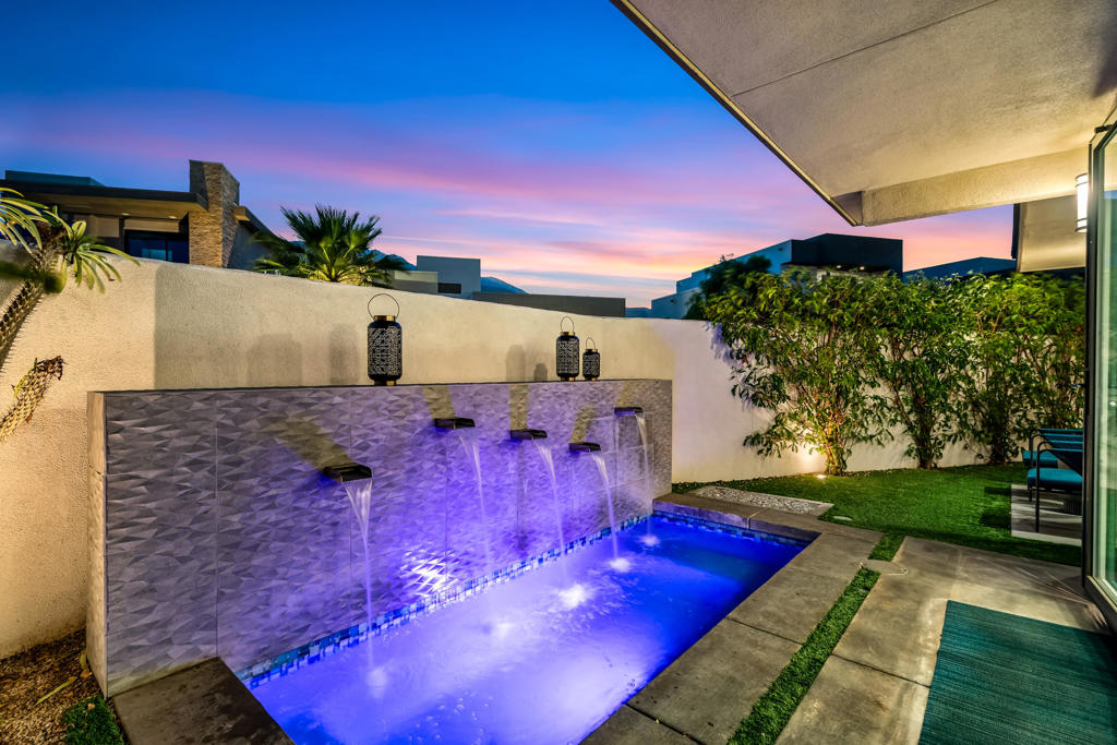 Perfectly situated in one of the best locations in the highly sought-after Vibe community, this highly upgraded home offers the best of both worlds ... ultimate privacy with stunning mountain views. This light and bright three-bedroom, three-bathroom home is situated on the corner with a large wraparound backyard and views galore. The tastefully updated gourmet kitchen with quartz countertops and designer backsplash opens to a spacious dining and living area, with fully retractable folding doors that overlook the pool with waterfall feature, firepit, and outdoor entertainment spaces. The primary bedroom is located on the main level and features a spa-like bathroom with an oversized walk-in closet. Also conveniently located on the main level is the third bedroom and bathroom, as well as a spacious laundry room. The upstairs loft features a large bonus area perfect for a media room, office, or home gym. Not to be missed is the oversized balcony with jaw-dropping views of Mt. San Jacinto. The well-appointed second primary ensuite bedroom is complete with a spa-like bathroom and walk-in closet. Additional upgrades include owned solar, professionally landscaped backyard with artificial turf, attached two-car garage with frosted glass door, tankless hot water heater, and plenty of storage. Community amenities are equally impressive and include a large, heated pool and spa with spacious deck for catching rays, clubhouse and gathering area with an outdoor grill, two dog parks, electric car charging, and bocce ball courts. This unique home is perfect as a primary residence, second home, or lucrative vacation rental.