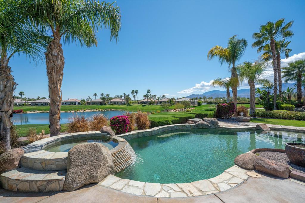 This stunning home in Mountain View Country Club is move in ready for you to enjoy the season. It offers approximately 2,535 sq ft of luxury living with 3 bedrooms and 4 bathrooms, designed for resort-style comfort and effortless indoor-outdoor living.The open floor plan features soaring ceilings, a corner fireplace, and a wall of windows that capture amazing views of the 15th fairway, lake, and Mountains. The gourmet kitchen is equipped with granite slab countertops, a center island and wet bar, creating the perfect space for entertaining.The primary suite is a private retreat with direct patio access, a spa-like bathroom with soaking tub, dual vanities, and a walk-in shower. Two spacious guest suites with en suite baths provide privacy for family and visitors. Additional features include abundant storage and a three-car garage with golf cart bay.Step outside to your private backyard oasis with a sparkling pool and spa, stunning mountain views, covered dining area, and multiple lounging spaces overlooking the fairway. This home is ideal for enjoying the desert lifestyle--whether relaxing in the sun or entertaining under the stars.Living at Mountain View Country Club offers access to world-class amenities including an Arnold Palmer Signature golf course, tennis, pickleball, bocce, fitness center, spa services, and a vibrant clubhouse with dining and social events. The location is minutes from Old Town La Quinta, fine dining, shopping, hiking trails, and the best of the Coachella Valley.This exceptional property is perfect as a full-time residence or as a seasonal retreat. With its golf course setting, resort-style pool, and luxury finishes, this home delivers the ultimate La Quinta lifestyle in one of the desert's most desirable country clubs.