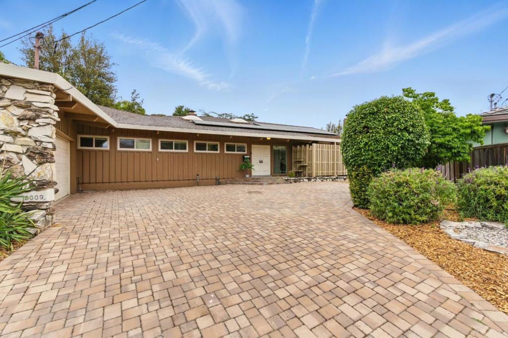 Nestled on a quiet cul-de-sac, this beautifully maintained mid-century style home offers resort-style living with exceptional privacy. Enjoy the sparkling pool, owned solar energy system, and expansive outdoor areas perfect for relaxing or entertaining. Inside, the home features exposed vaulted beam ceilings in the living room, dining room, primary bedroom and family room, creating a bright and open atmosphere. Floor-to-ceiling windows span the entire back of the house, bringing in abundant natural light and seamless indoor-outdoor flow. The spacious primary bedroom includes two closets, an updated en-suite bathroom, and a unique hidden door leading to a bonus room with its own separate entrance and bathroom......ideal for a home office, studio, or guest suite. Additional highlights include a large laundry room, a separate utility room, and thoughtful updates throughout. A rare find that perfectly blends iconic style with modern convenience and privacy.
