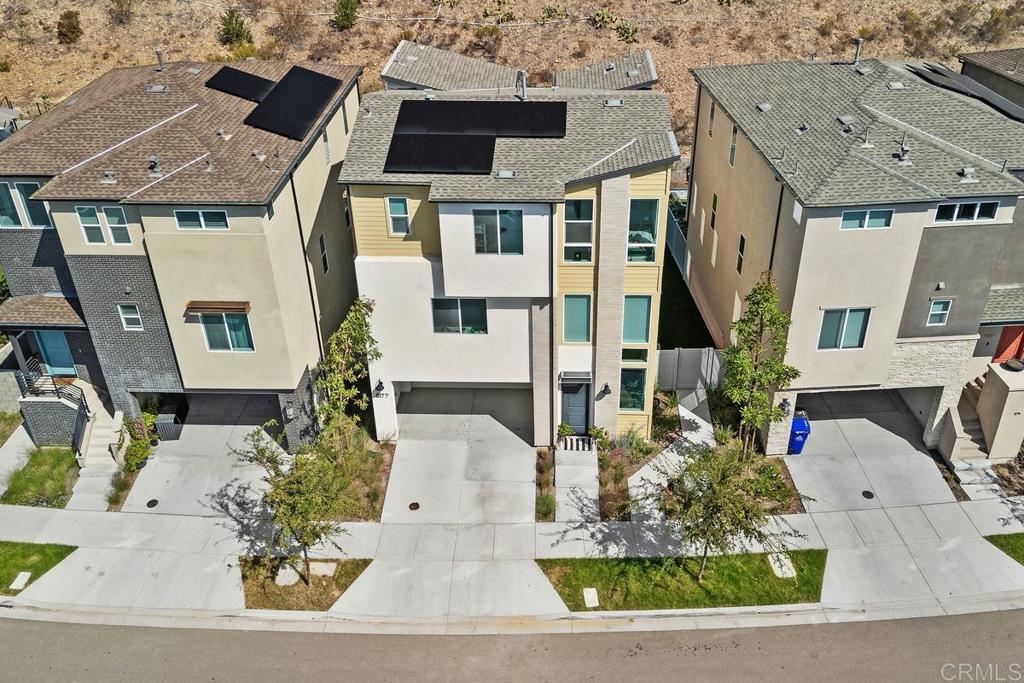 Citrine at 3Roots – Sorrento Mesa: Modern living awaits in this newly constructed Citrine residence, set on a premium-size lot with a view of the canyon hill reserve (open space) within the desirable 3Roots master-planned community. Offering 4 spacious bedrooms, 3.5 baths, and 2,316 sq. ft., the home’s contemporary floor plan is designed for comfort and function. Sun-filled interiors showcase upgraded flooring, quartz countertops, custom cabinetry, and premium stainless steel appliances throughout the chef-inspired kitchen. On the entry level, a versatile suite with an ensuite bath provides the perfect space for guests or a dedicated home office. The second floor opens to expansive living and dining areas, seamlessly connected to a covered balcony—ideal for entertaining or enjoying California’s indoor-outdoor lifestyle. The owner’s suite is a restful retreat featuring a luxurious bath with a soaking tub and a private balcony. Continuing, there are two spacious secondary bedrooms and a full bathroom with a double sink vanity on the same floor. Additional features include a two-car garage and drought-tolerant landscaped grounds. Eco-friendly living with rooftop solar, Smart home technology, integrated air filtration system, providing sustainable energy and long-term savings, and Ring security. Residents of 3Roots enjoy access to an exclusive array of amenities: a cutting-edge fitness center, resort-inspired pool, multiple parks, playgrounds, sports courts, and scenic walking trails throughout the community, reflecting a commitment to wellness and convenience. Perfectly positioned in Sorrento Mesa, this home offers quick access to area beaches, shopping, dining, and major employment centers. Contact today for a private showing and make this exceptional Citrine home your next address in San Diego.