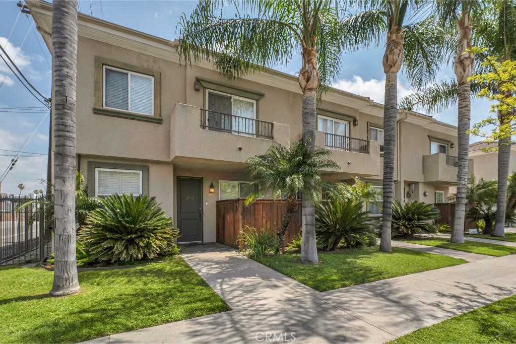 Rare 4 bedroom/ 2.5 bath prime end-unit with 1,592 sq ft townhome in gated community offers a rare blend of privacy, space, and comfort. The front entry, decorated with iconic palm trees, opens directly into the open floorplan main level with hardwood floors, crown molding, and recessed lighting throughout. The spacious living area boasts plantation shutters and sliding glass door access to the private front patio, perfect for BBQs or lounging and soaking in the sun! A cozy dining area, off the kitchen and living room, offers a place to gather with friends and family. The roomy kitchen offers granite counters, a central island, abundant cabinets for storage, and a full suite of appliances including a gas range, electric oven, microwave, dishwasher, and garbage disposal. The main floor offers a convenient powder bath and direct access to the private, attached, 2-car garage with built-in storage. Upstairs is a convenient, dedicated laundry area and all the bedrooms. The primary suite is a secluded oasis with recessed lighting, crown molding, large walk-in closet, plantation shutters, and a sliding glass door to a private front-facing balcony. The full, en-suite bath includes a double-sink vanity, crown molding, and tile accents. Three additional bedrooms, each with high ceilings, mirrored closets, and carpeting, share a full hall bath. Additional features include ceiling fans to keep cool and a tankless water heater. Wonderfully situated near to the Warner Center, The Village, shops, dining, entertainment, recreation and freeway access. Don’t let this one pass you by!